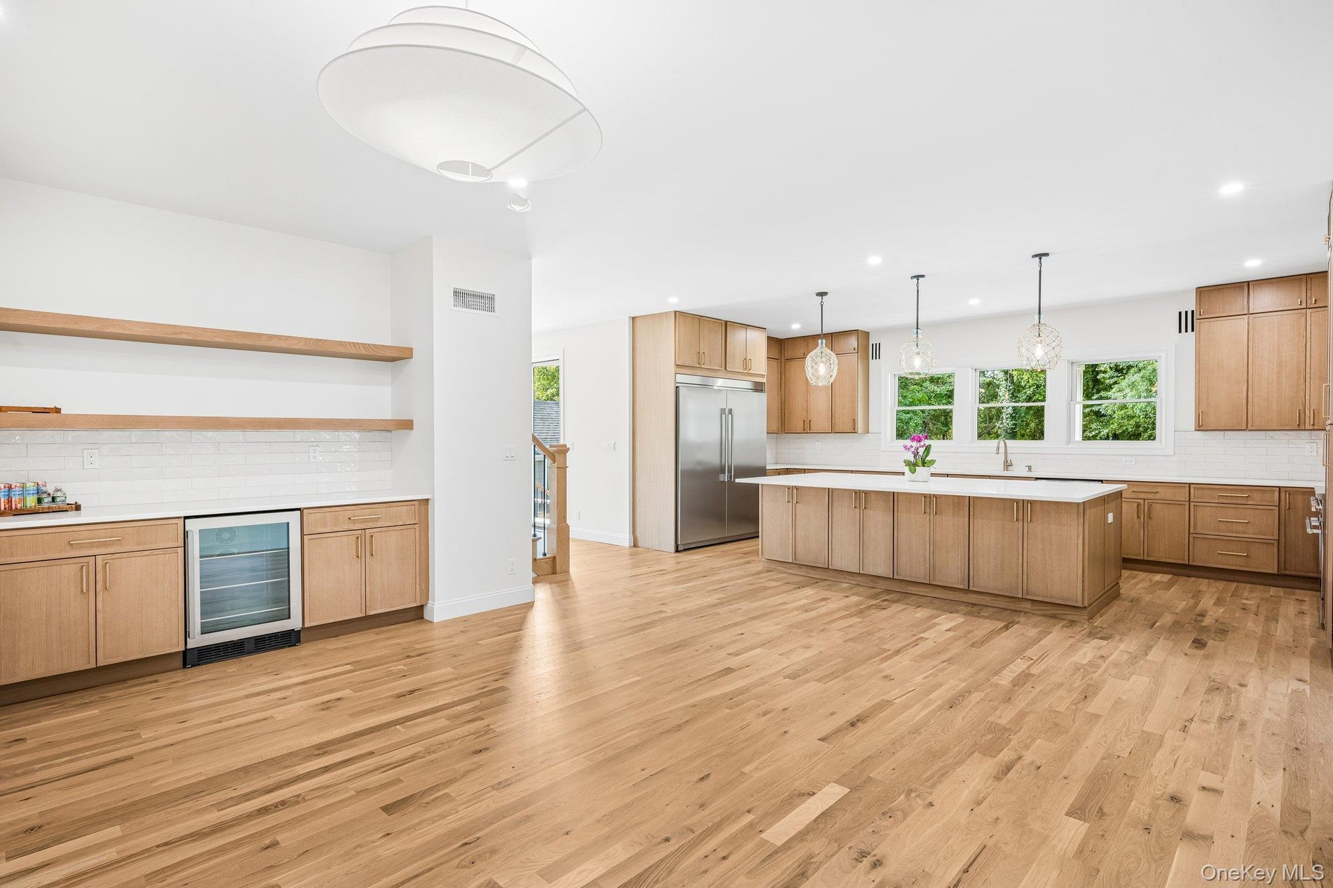 Kitchen flows to dining in one sunlit sweep. Saturday afternoons bring Open Chess at the Bayport-Blue Point Library, about 700 feet away, then home to