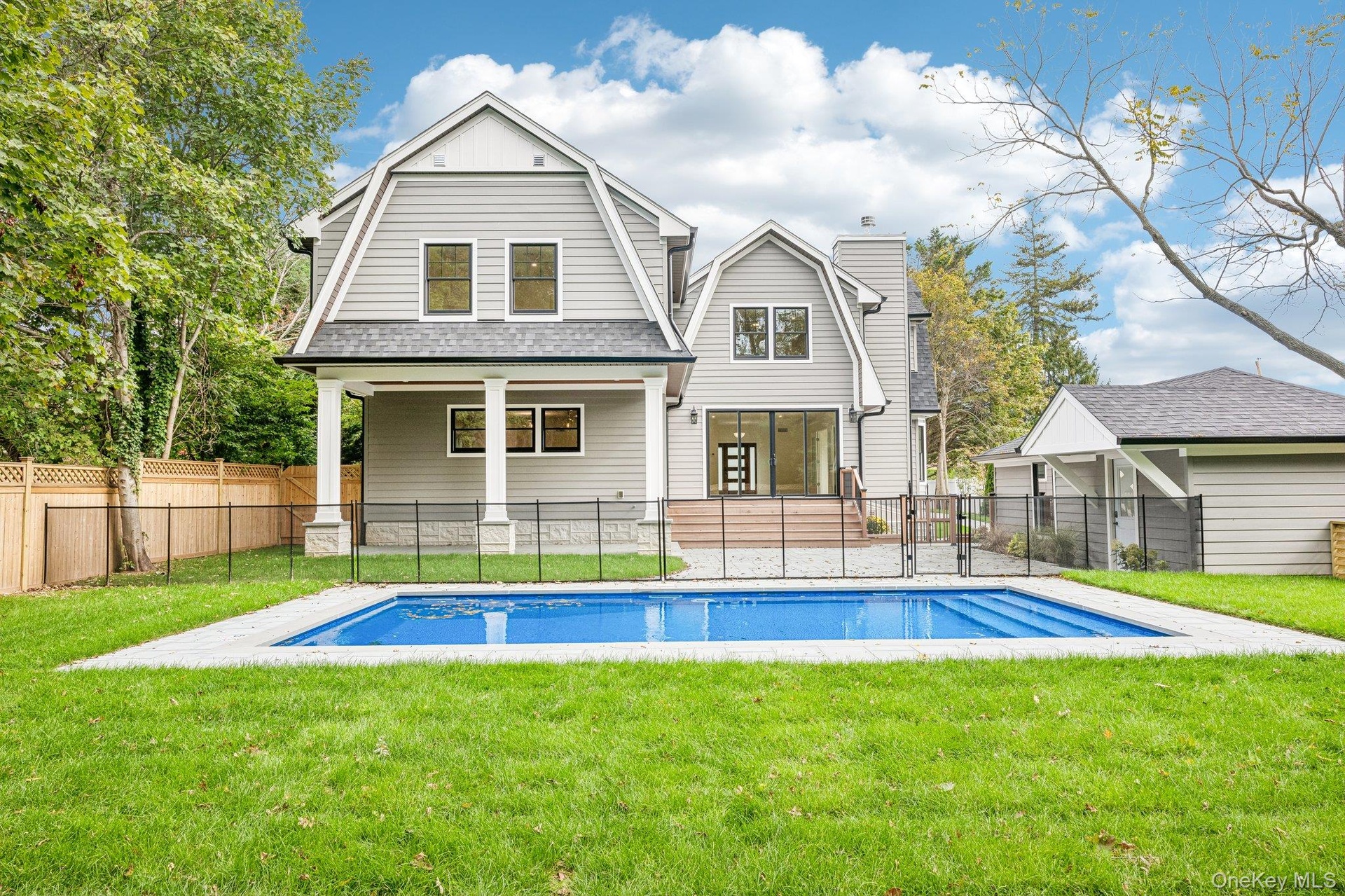 The rear facade over a new in-ground heated saltwater pool. Bring the bay home: Bodhi's beach bar at Corey Beach, about 0.7 miles away, hosts weekend 
