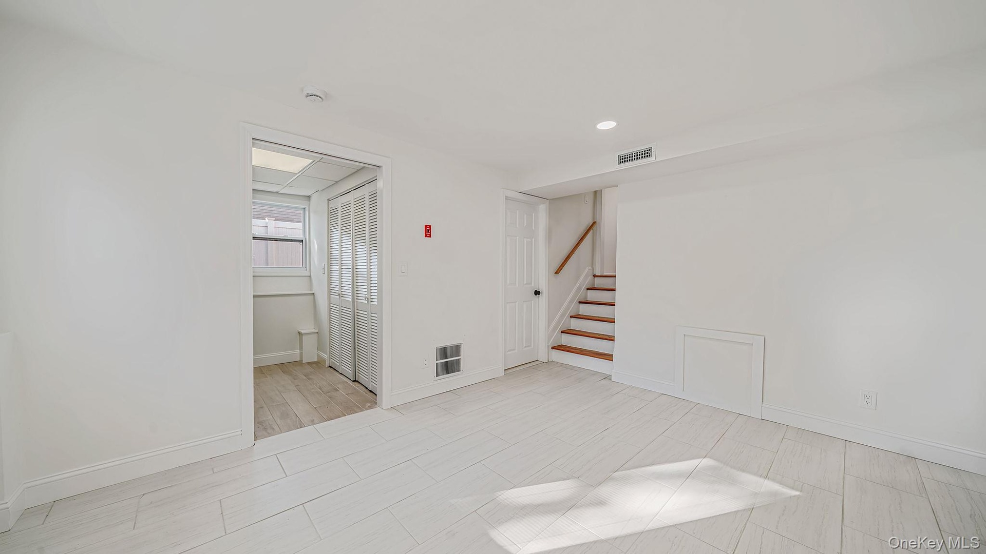 Entrance to lower level and full bath and laundry room