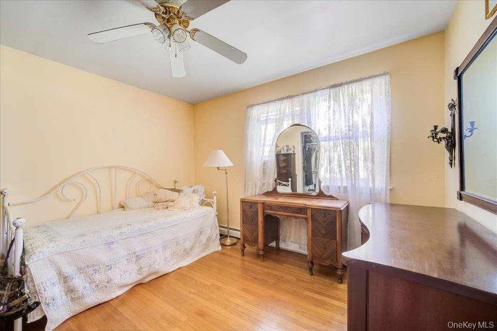 Third of 4 sunny bedrooms with hardwood floors.