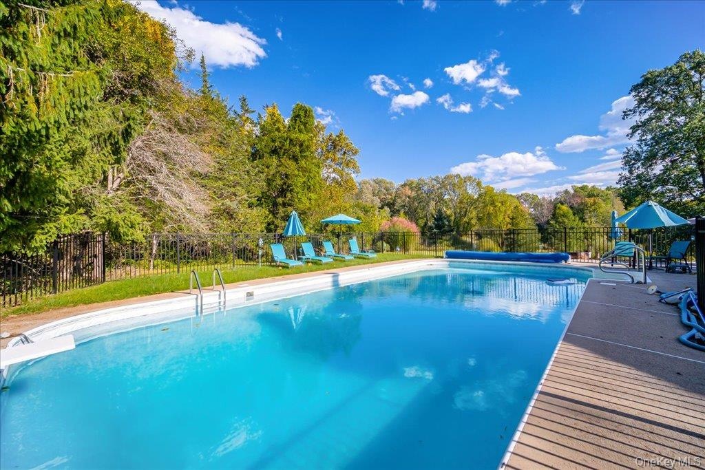 Lovely oversized inground pool with paver surround and sunny lounge area!