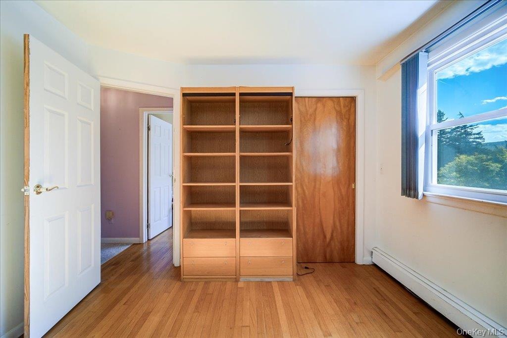 One of 4 large bedrooms with hardwood floors.