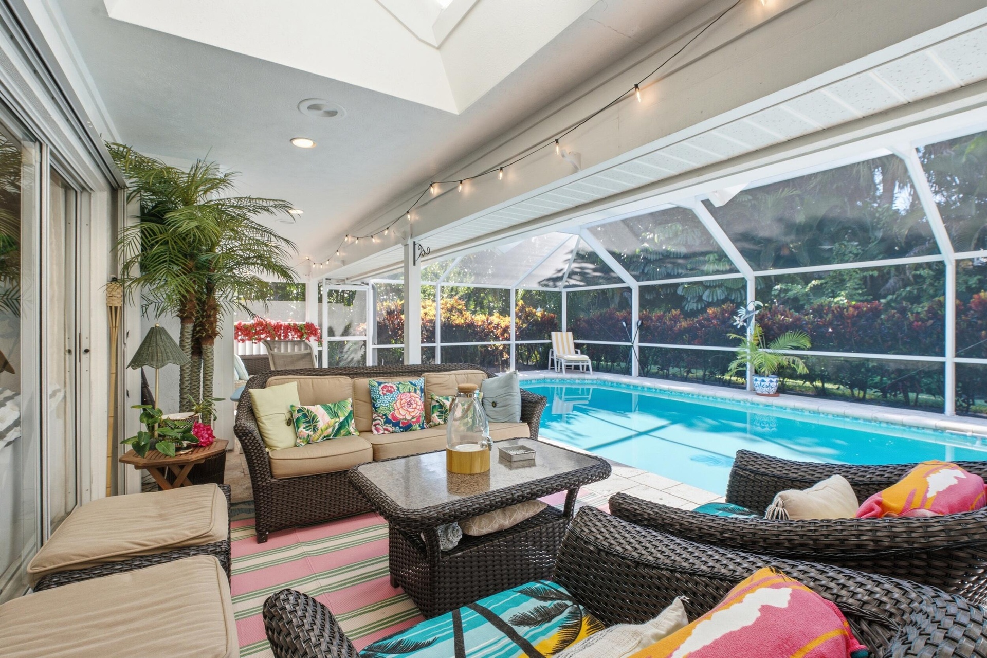 Screened-in lanai featuring a vaulted ceiling, recessed lighting, and a private swimming pool with an enclosure