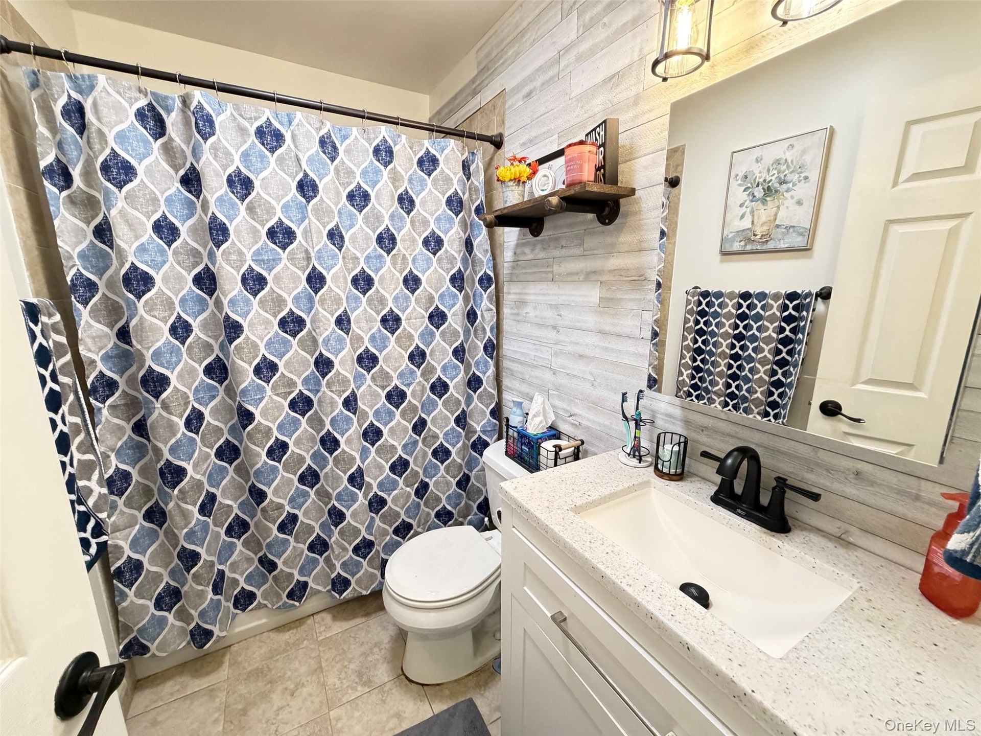 White vanity with integrated sink and speckled countertop