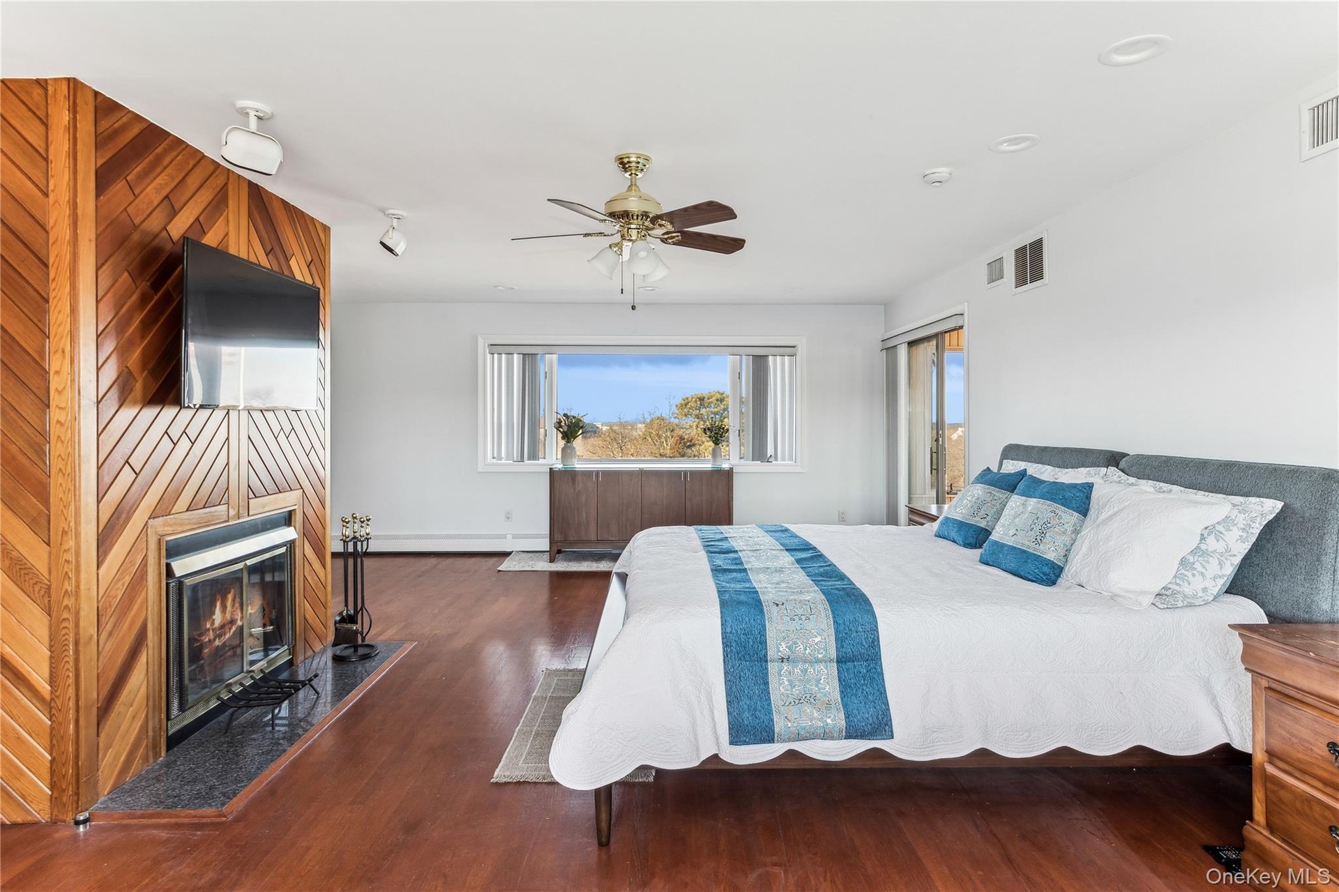 Bedroom featuring dark hardwood / wood-style floors and ceiling fan