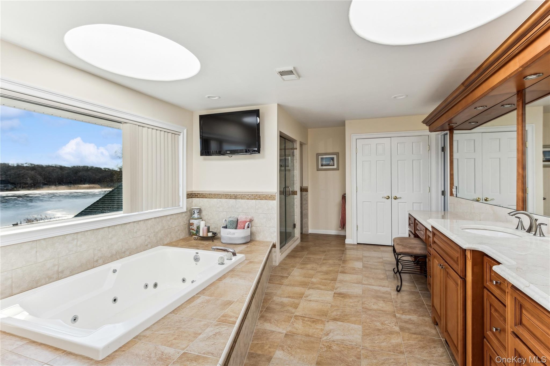 Bathroom with vanity and separate shower and tub