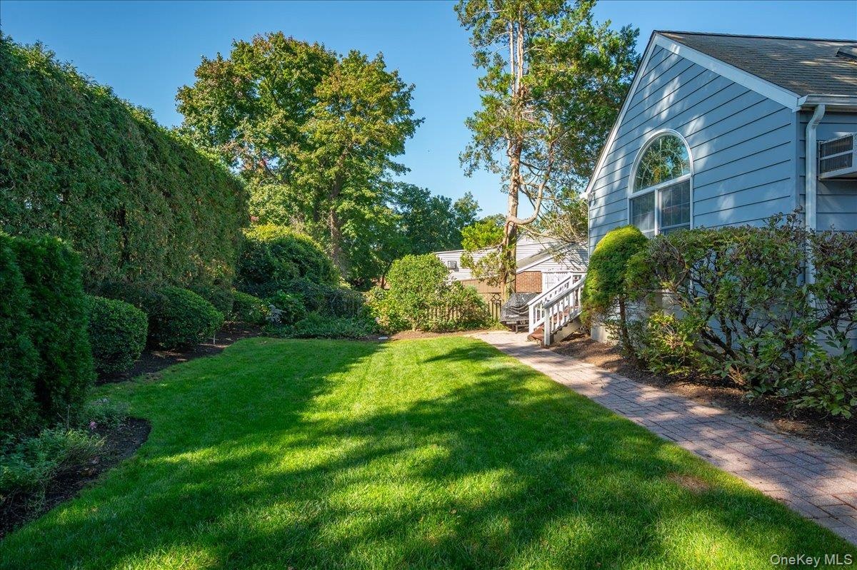 Mature trees and vibrant greenery transform this outdoor space into a serene sanctuary.
