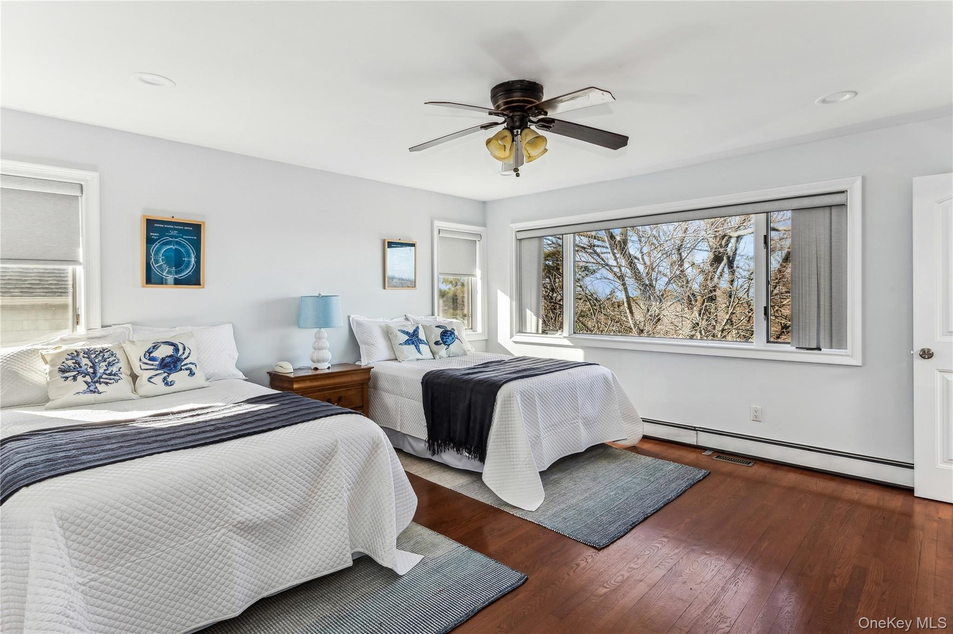 Bedroom featuring ceiling fan, dark wood-type flooring, and baseboard heating