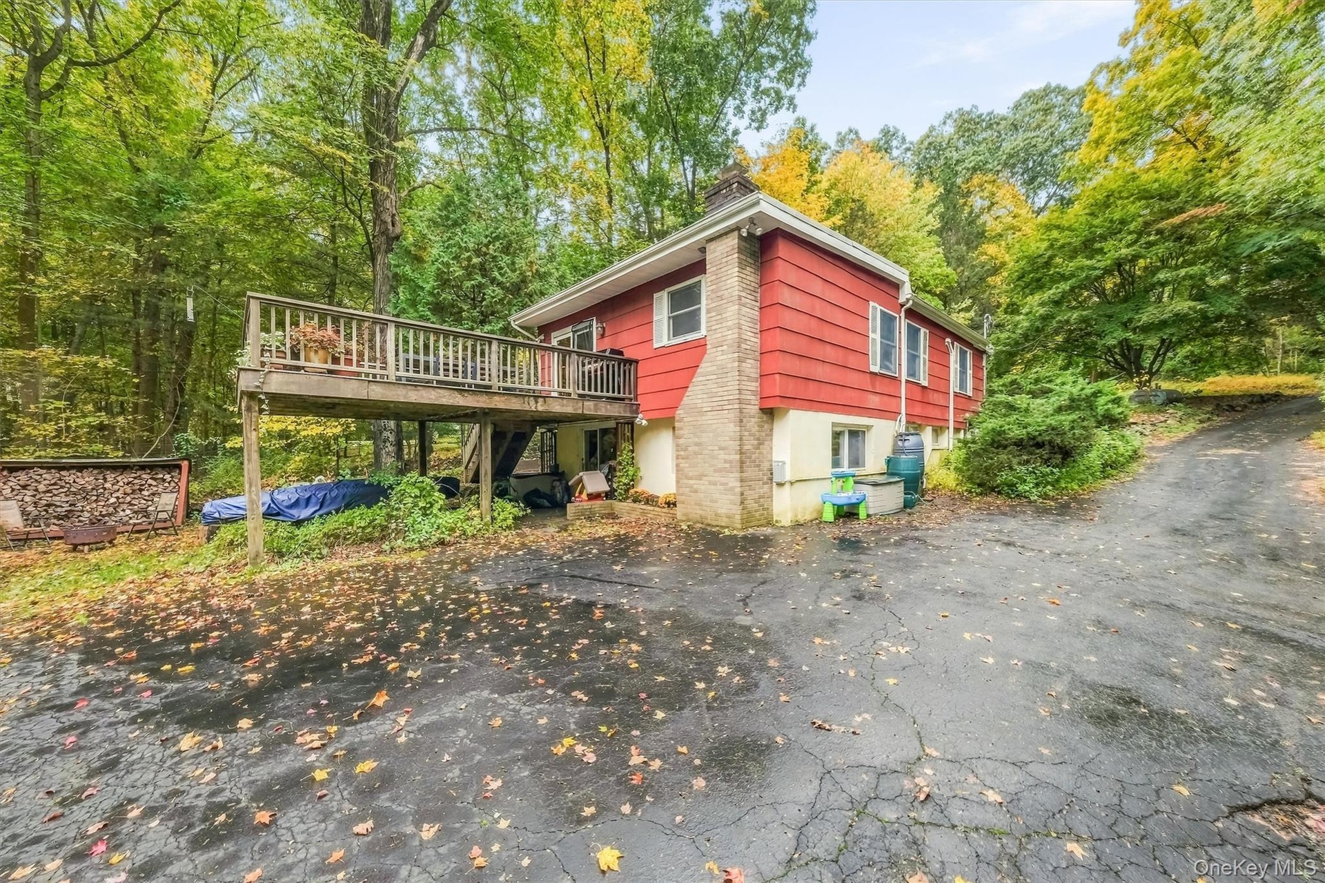 View of deck off kitchen and wide driveway for plenty of parking.