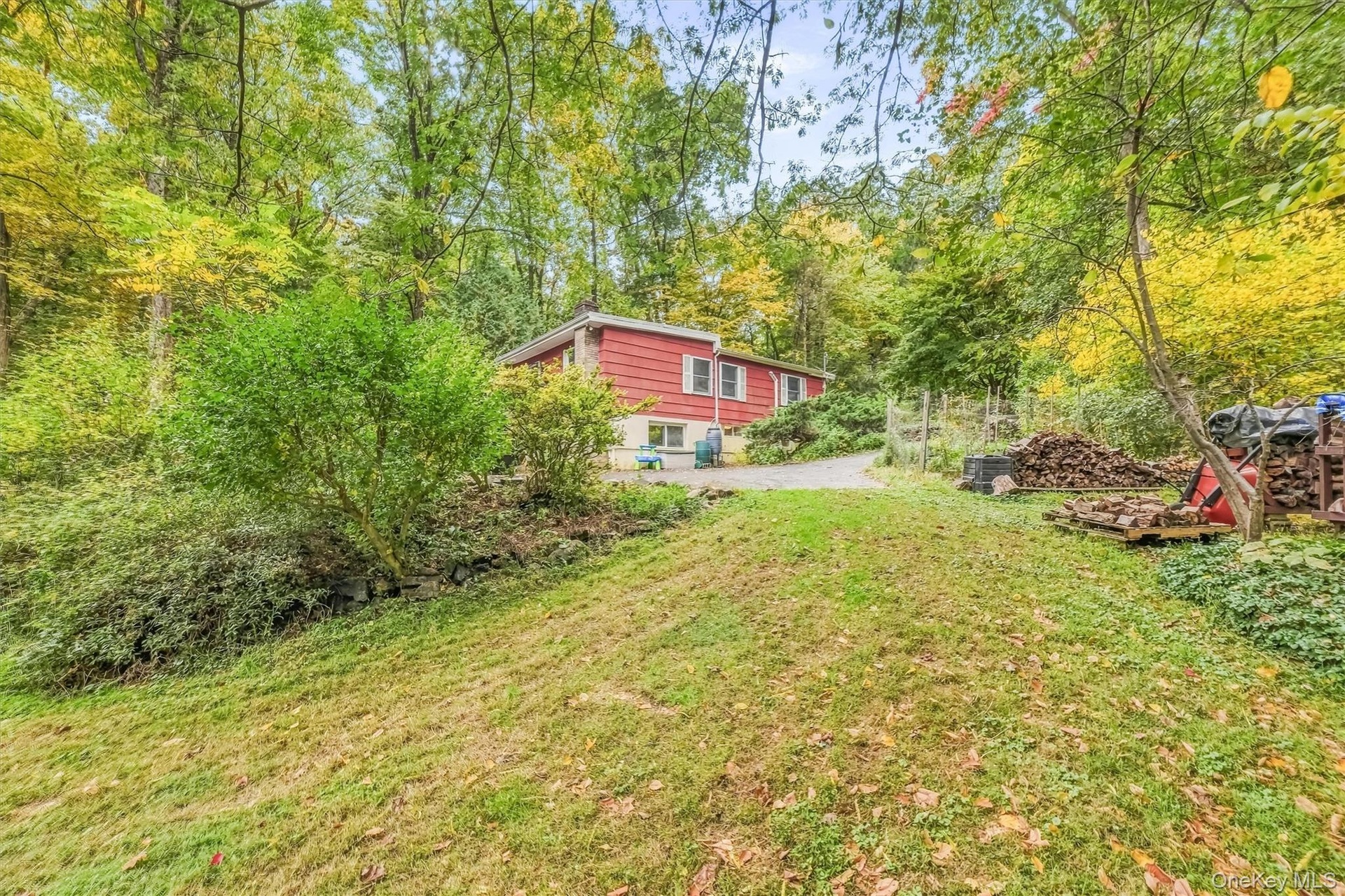 View of side of house from yard with garden.
