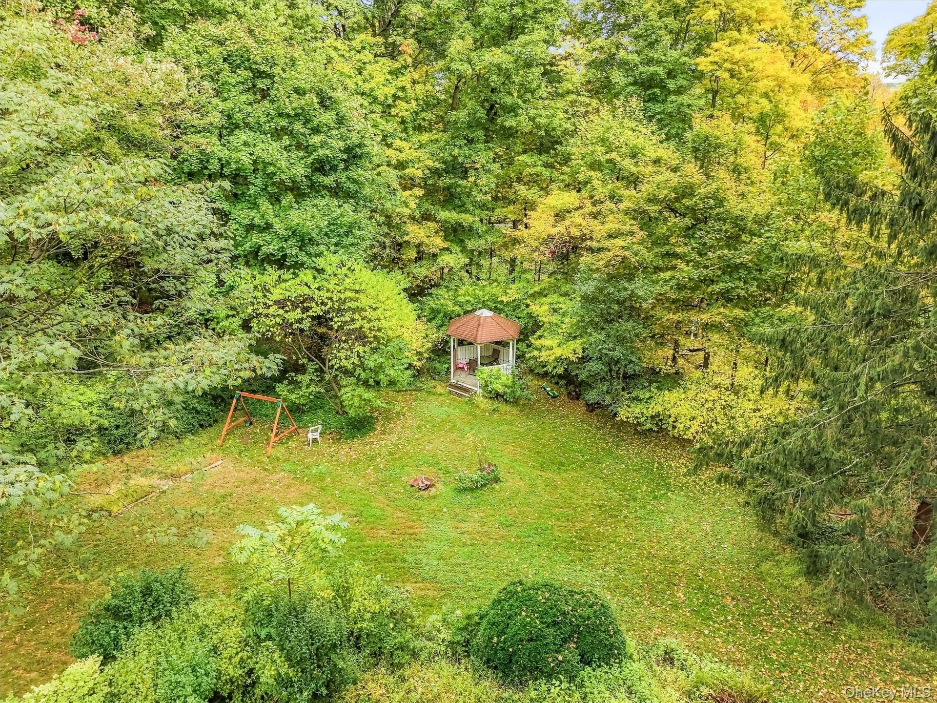 Rear yard is framed beautifully with the colors of Fall.
