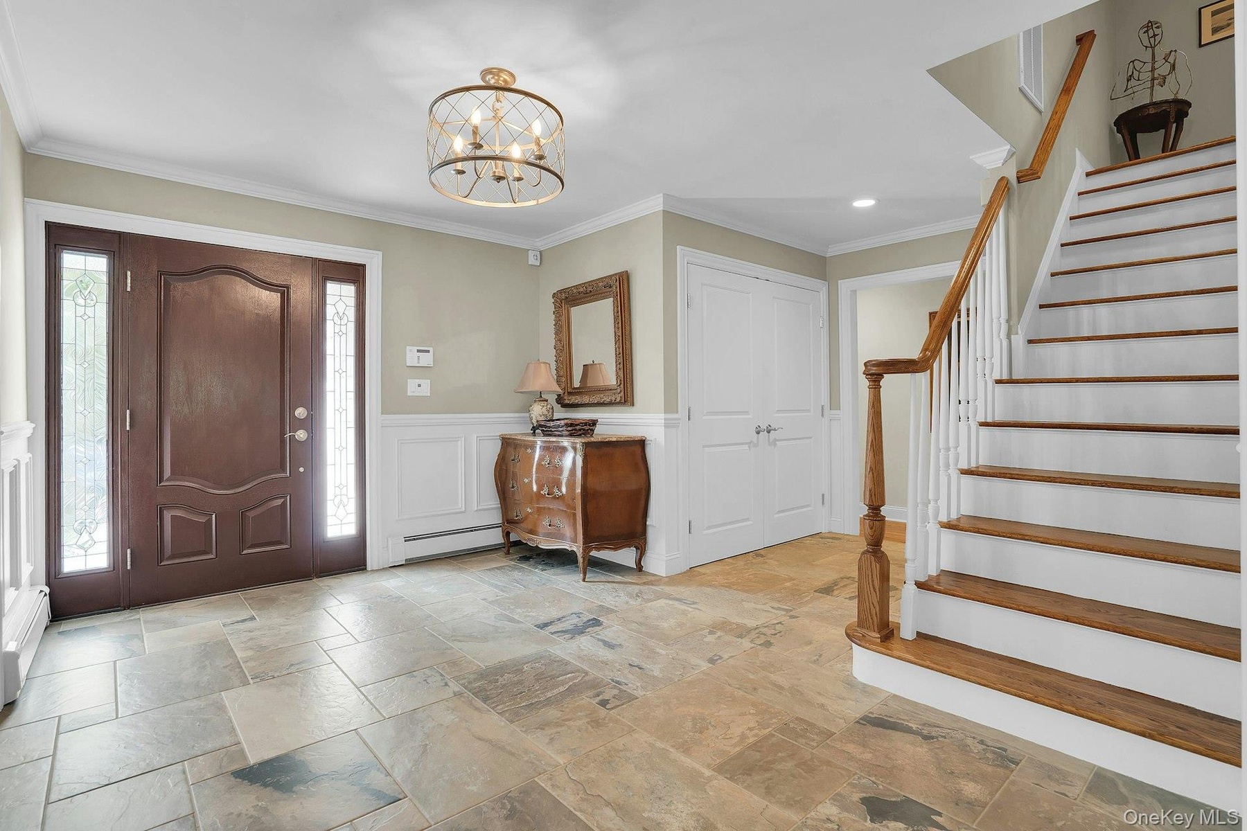 Gorgeous entry door and stne flooring.