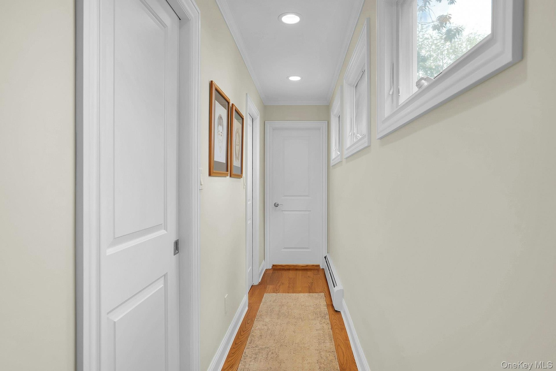 Hallway leads to 2 walk-in-closets and primary bathroom.