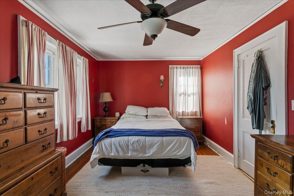 Ceiling fan and hardwood flooring complete this space