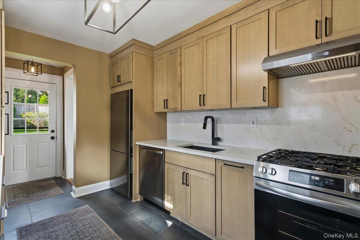 With slate tile flooring and SS appliances