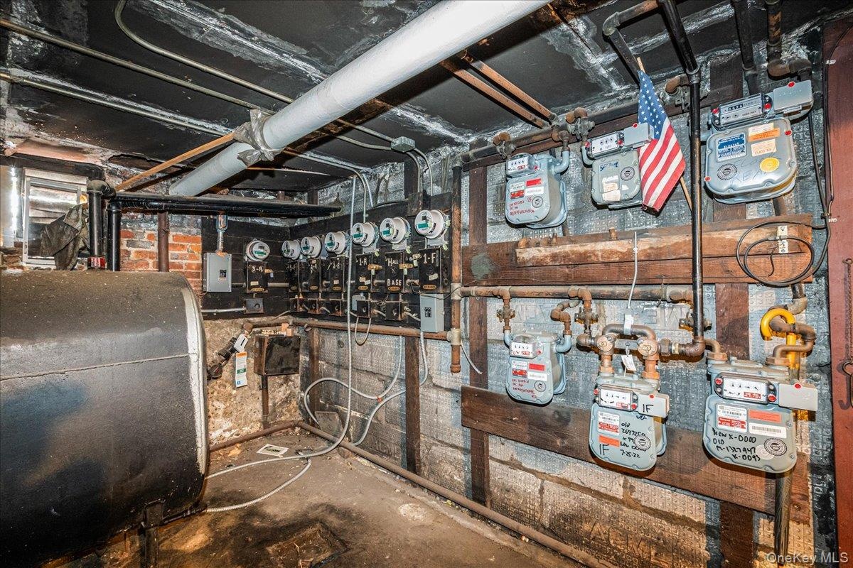 Utility room featuring oil tank and electric panel