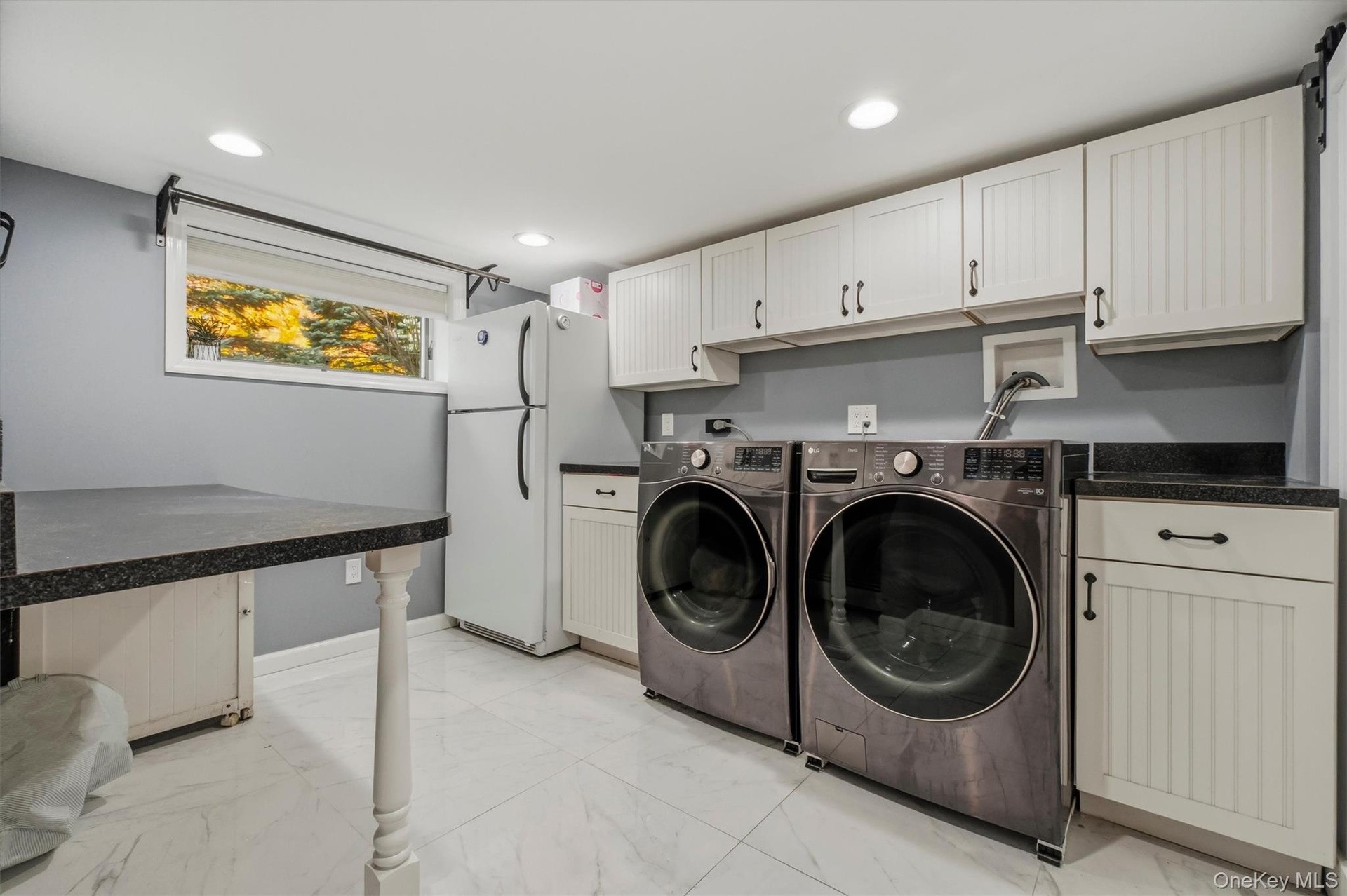 Great cabinet & counter space in updated laundryroom.