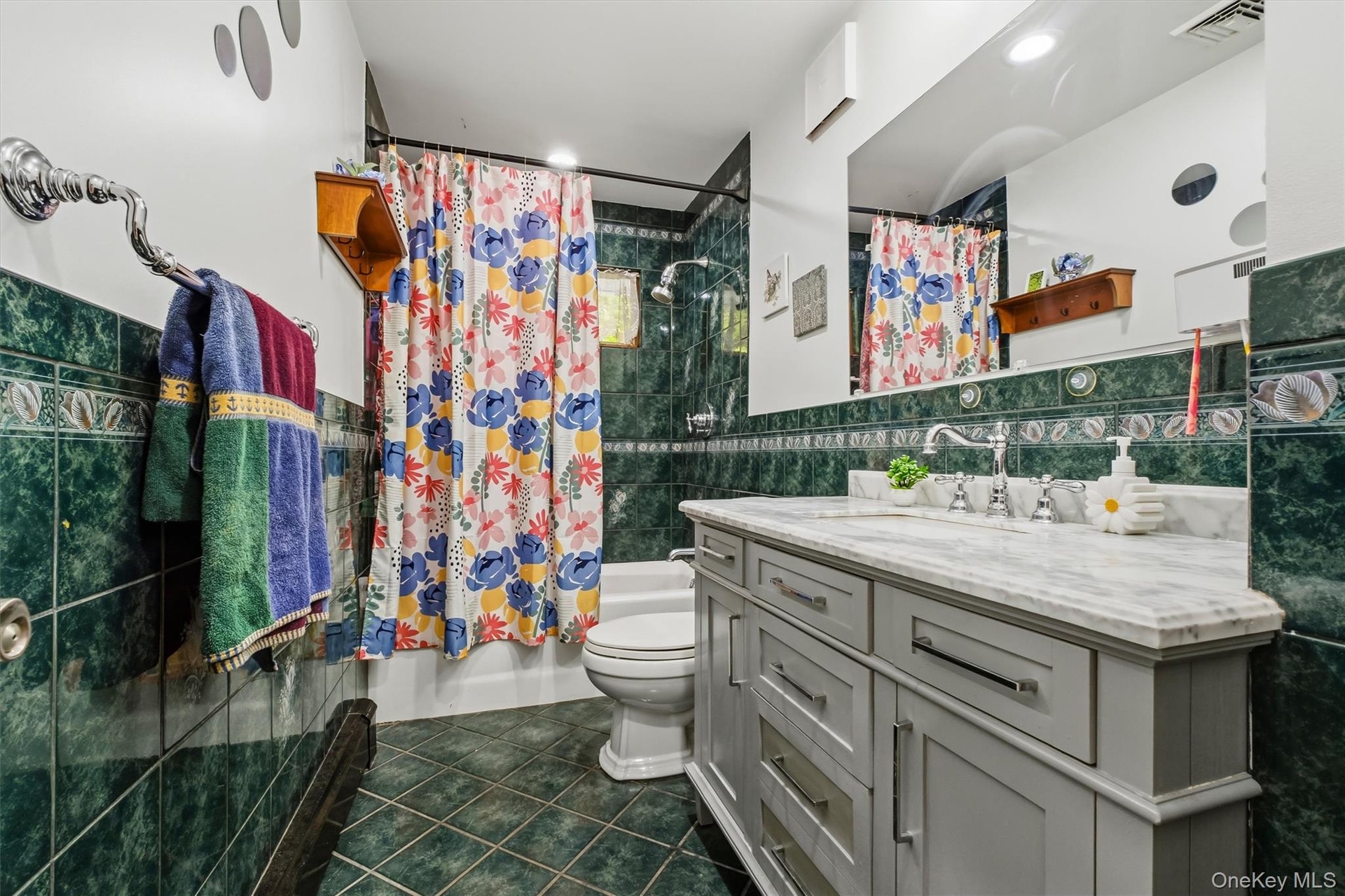 Tiled full bath w/newer vanity.