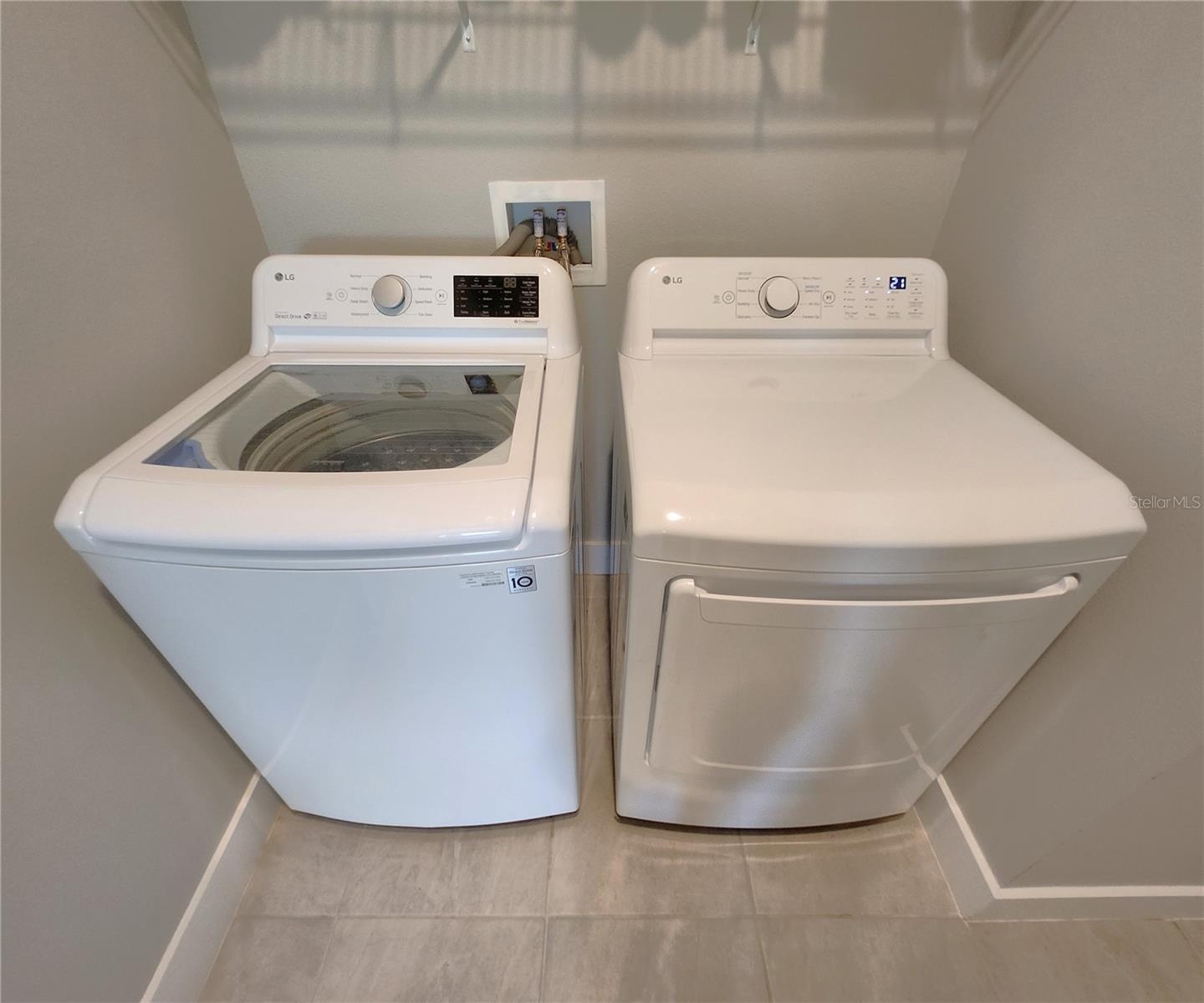Interior Laundry Room includes side-by-side washer and dryer, ventilated shelves, and storage space