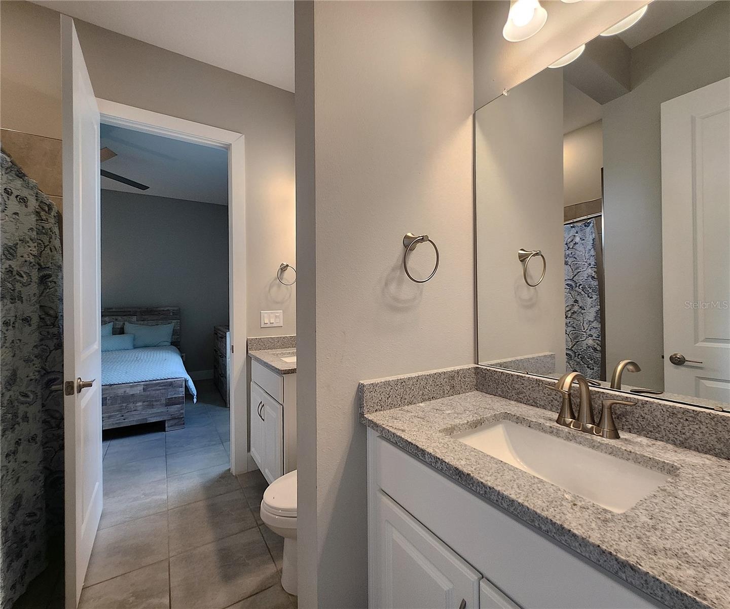 Jack-n-Jill Bathroom includes separate sink vanities, bathtub/shower combo