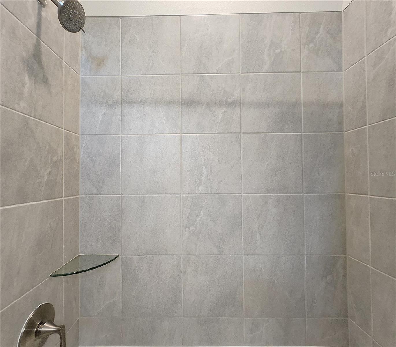Jack-n-Jill Bathroom includes separate sink vanities, bathtub/shower combo