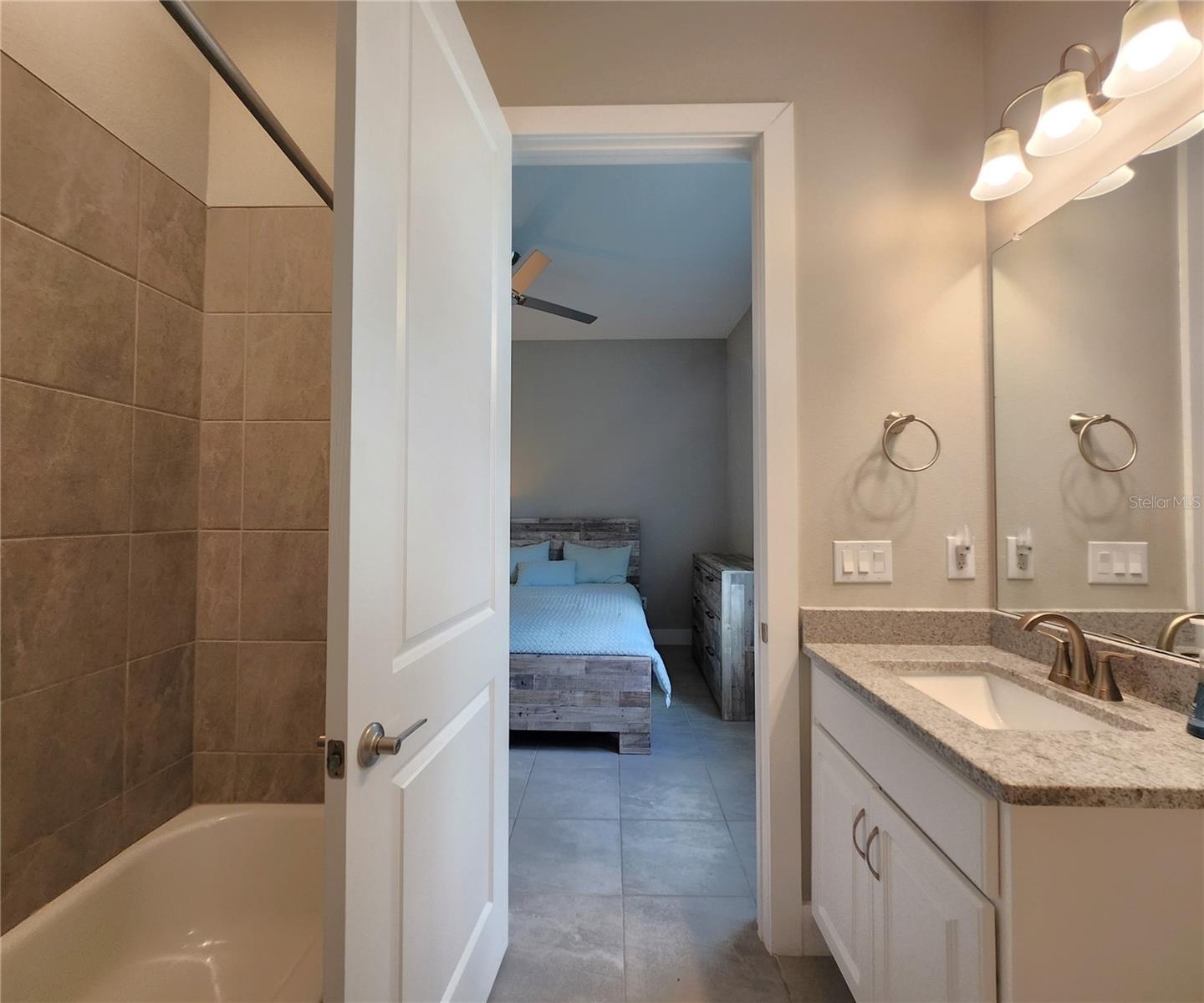 Jack-n-Jill Bathroom includes separate sink vanities, bathtub/shower combo