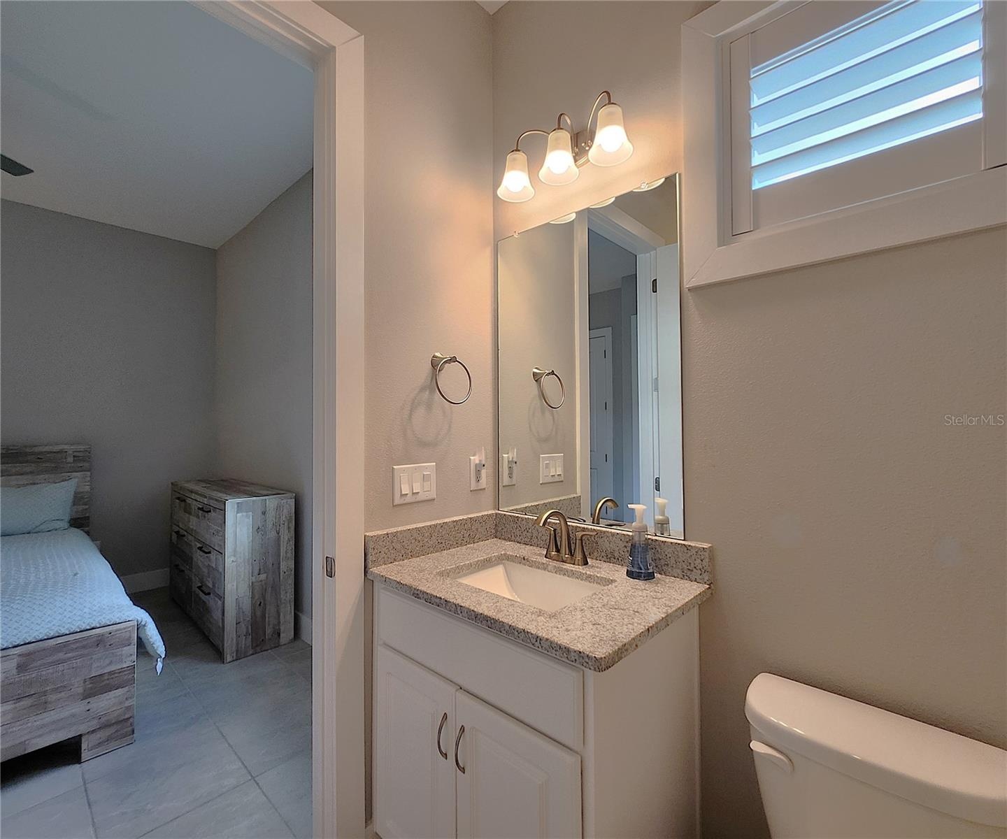 Jack-n-Jill Bathroom includes separate sink vanities, bathtub/shower combo