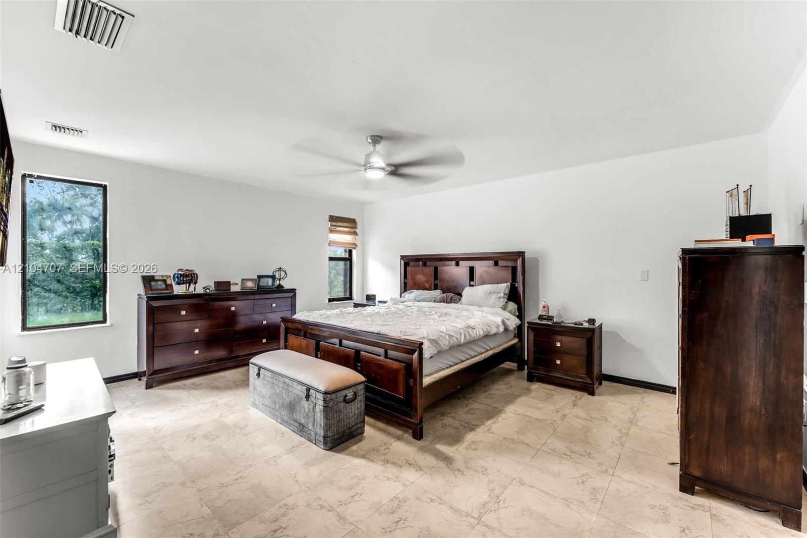 Neutral tile flooring and ceiling-mounted fan with integrated lighting