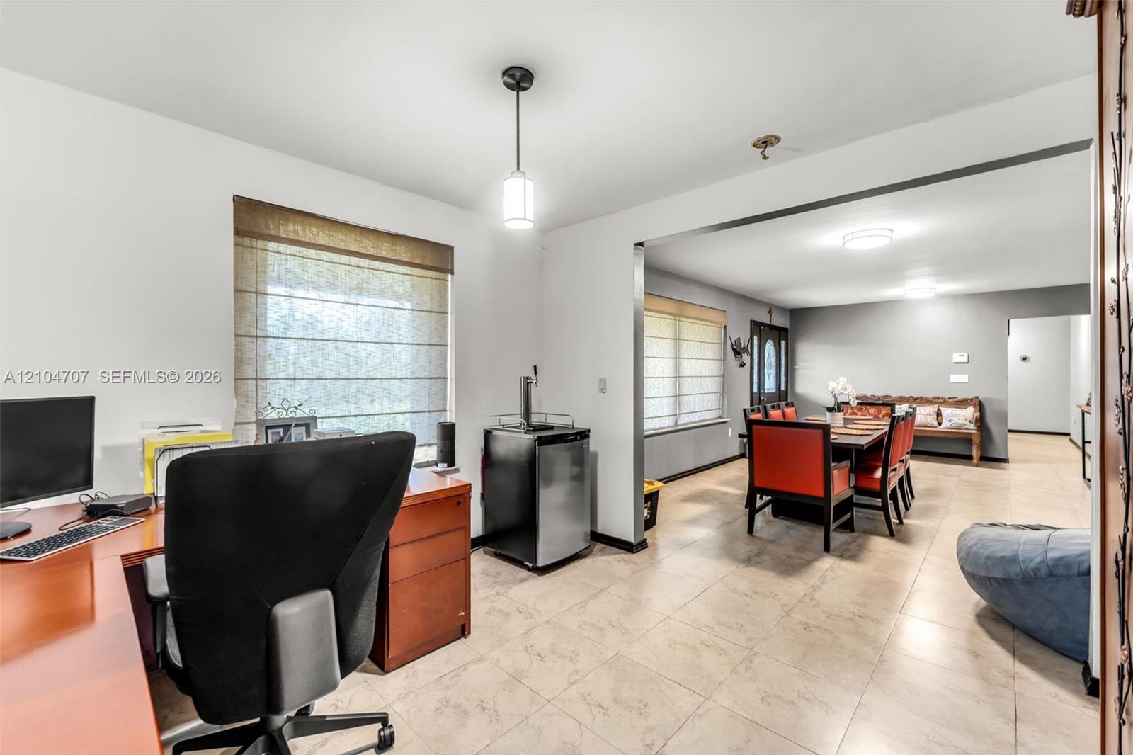 Open floor plan featuring large format tile flooring, neutral wall tones, and recessed ceiling lighting