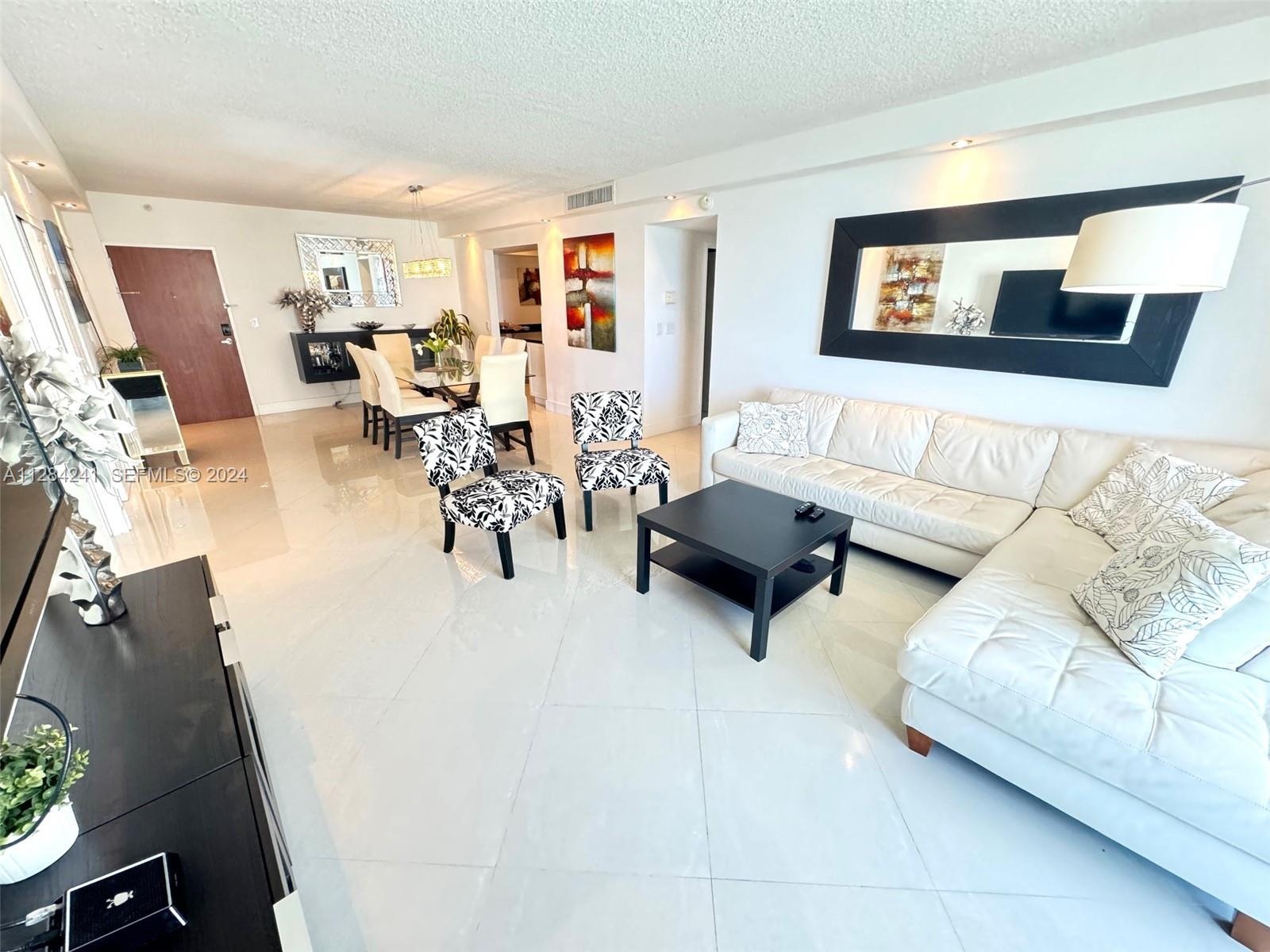 white leather sect sofa, Large Flat TV, upscale furnished