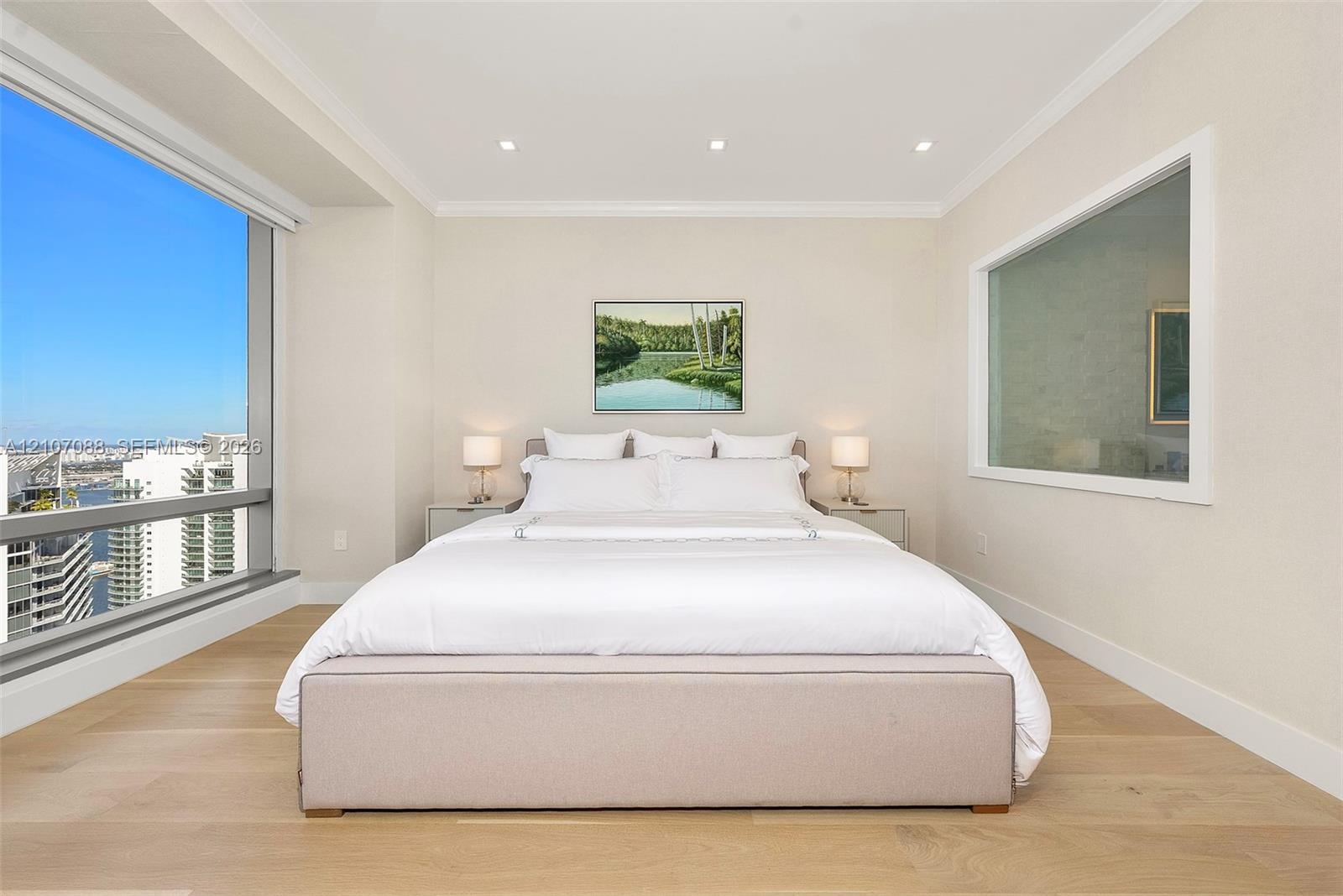 Floor-to-ceiling windows, wood-finish flooring, recessed lighting, and crown molding