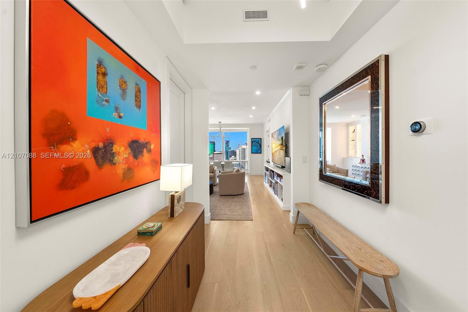 Entryway with linen closet on the left and kitchen to the right