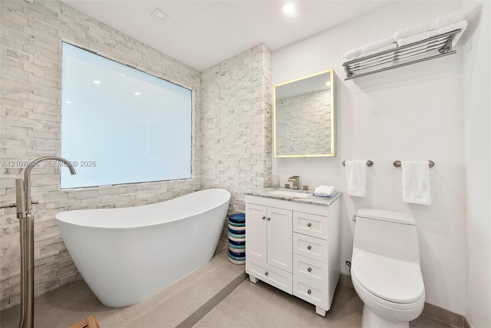 Primary Bathroom with shower and separate soaking tub. Switchable privacy glass