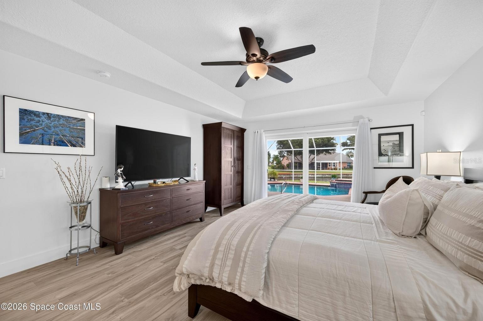 Primary suite with pool and lake views