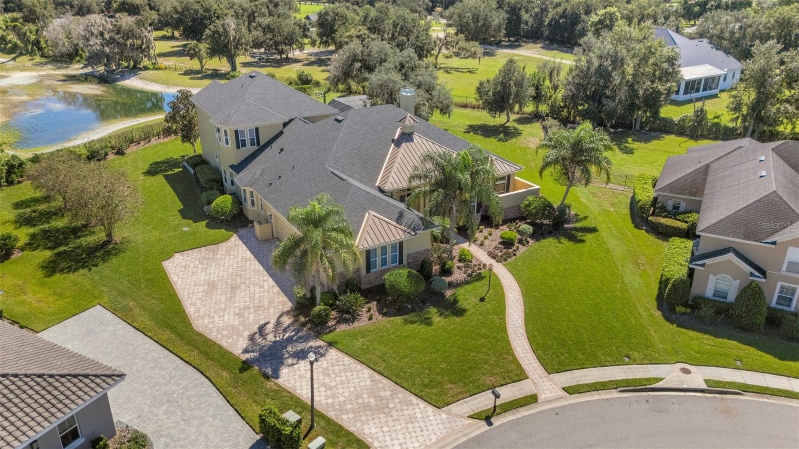 The home has a full brick paver driveway leading to a 4-car (YES, 4-CAR) garage, sidewalks and so much more.