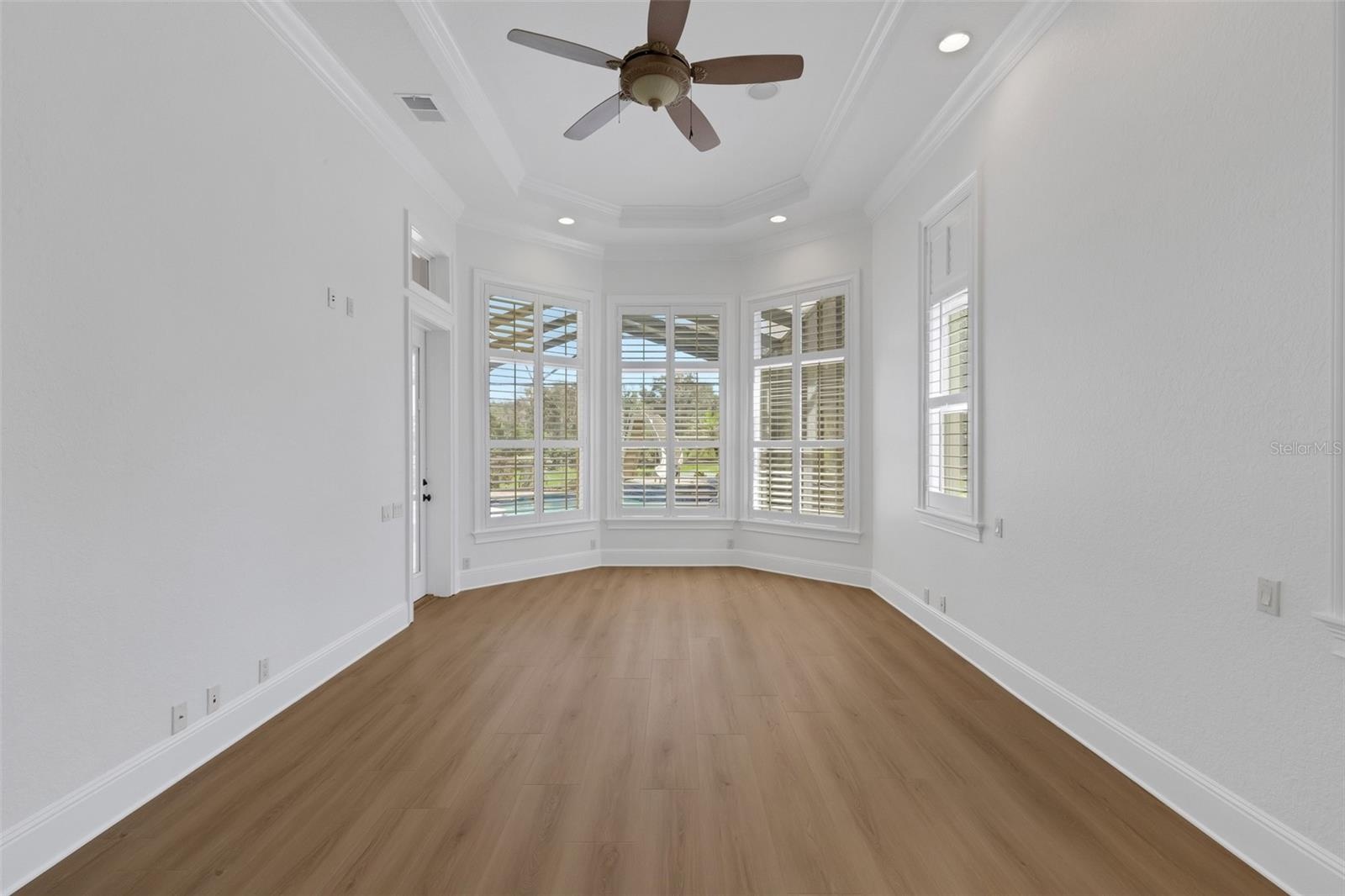 designed for a sitting area that overlooks the pool and backyard beyond.