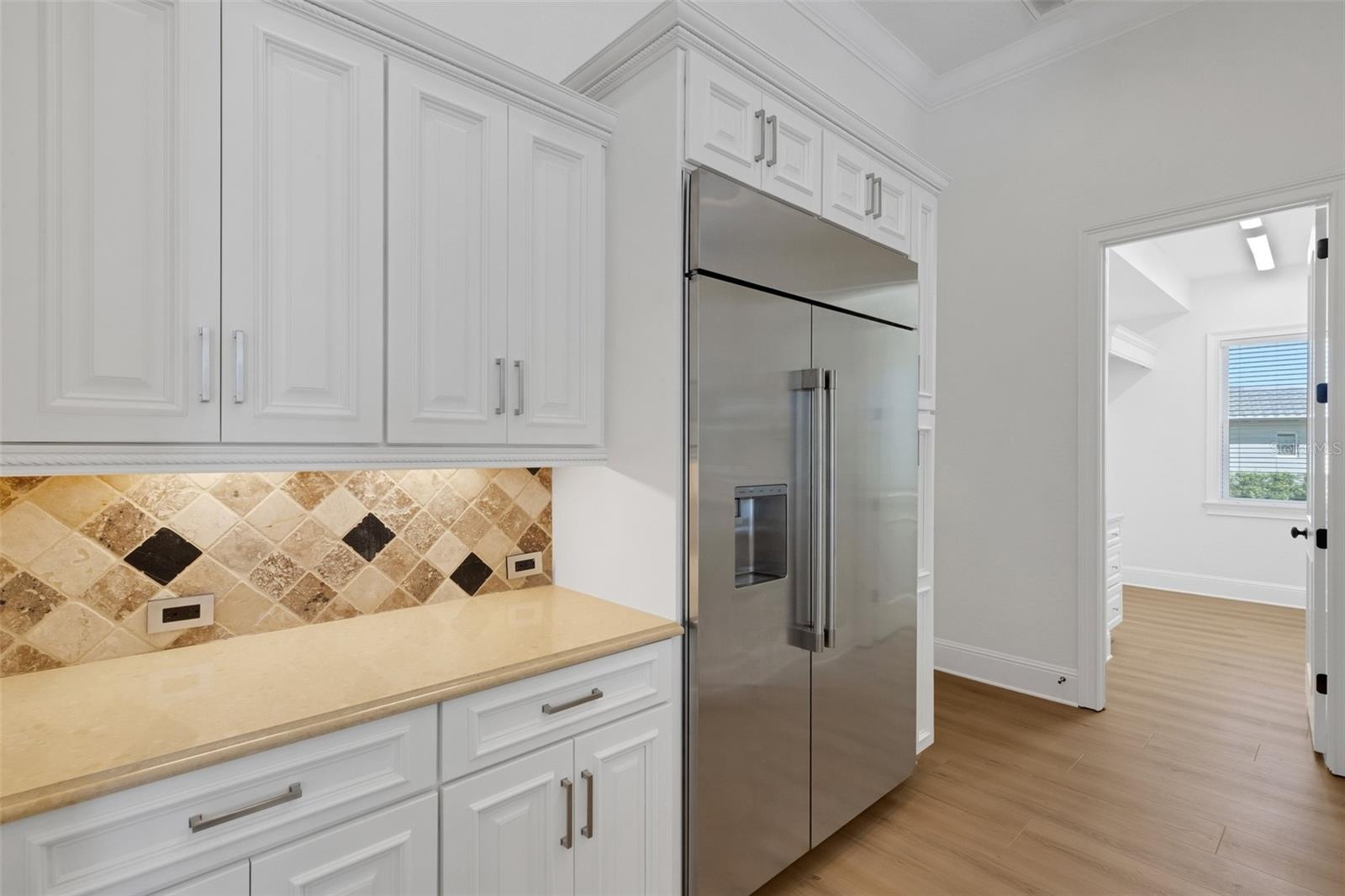 Solid surface countertops with travertine backsplash, under cabinet lighting and more.