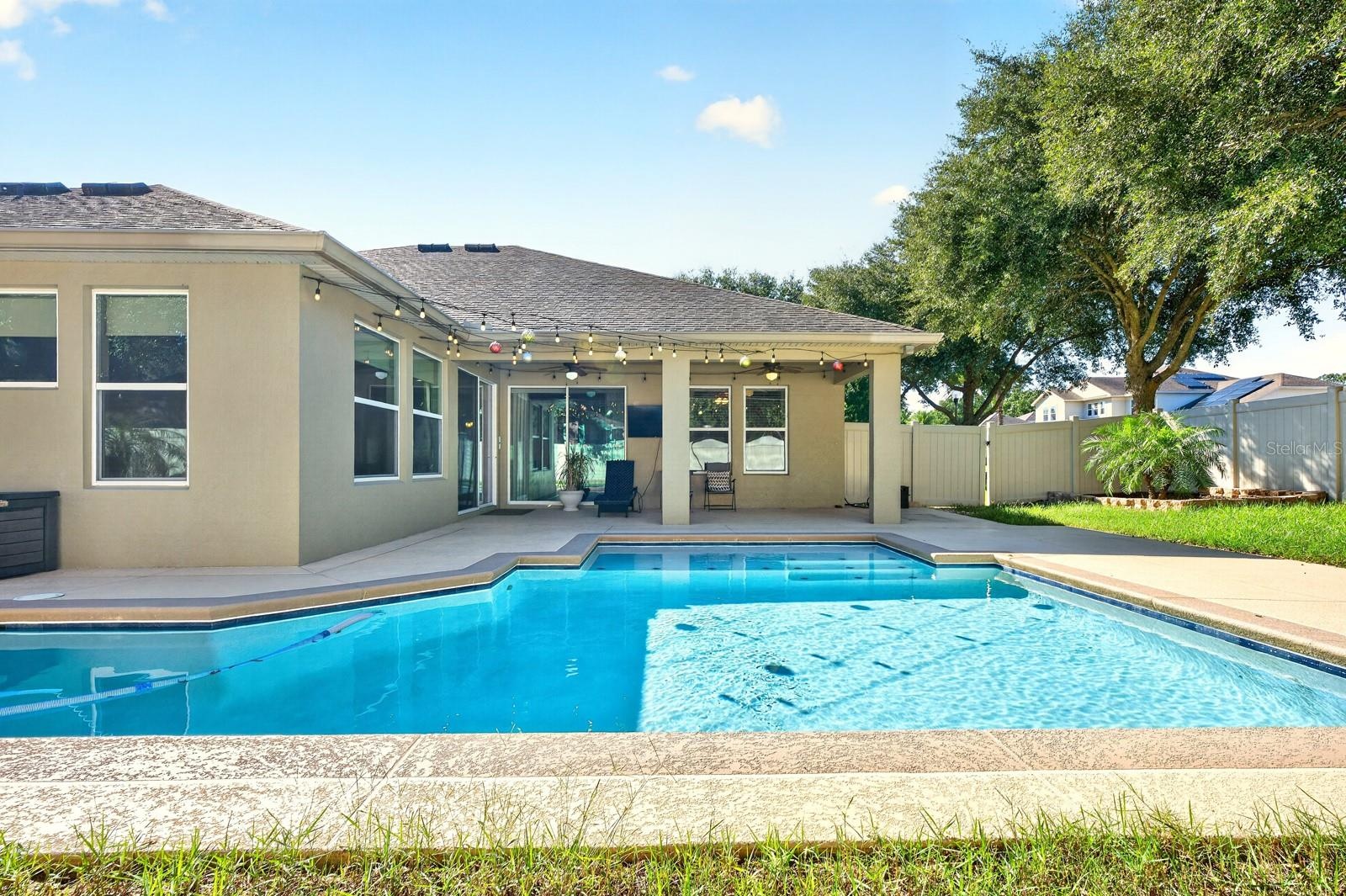 The covered lanai overlooks your private pool and privacy fenced backyard.