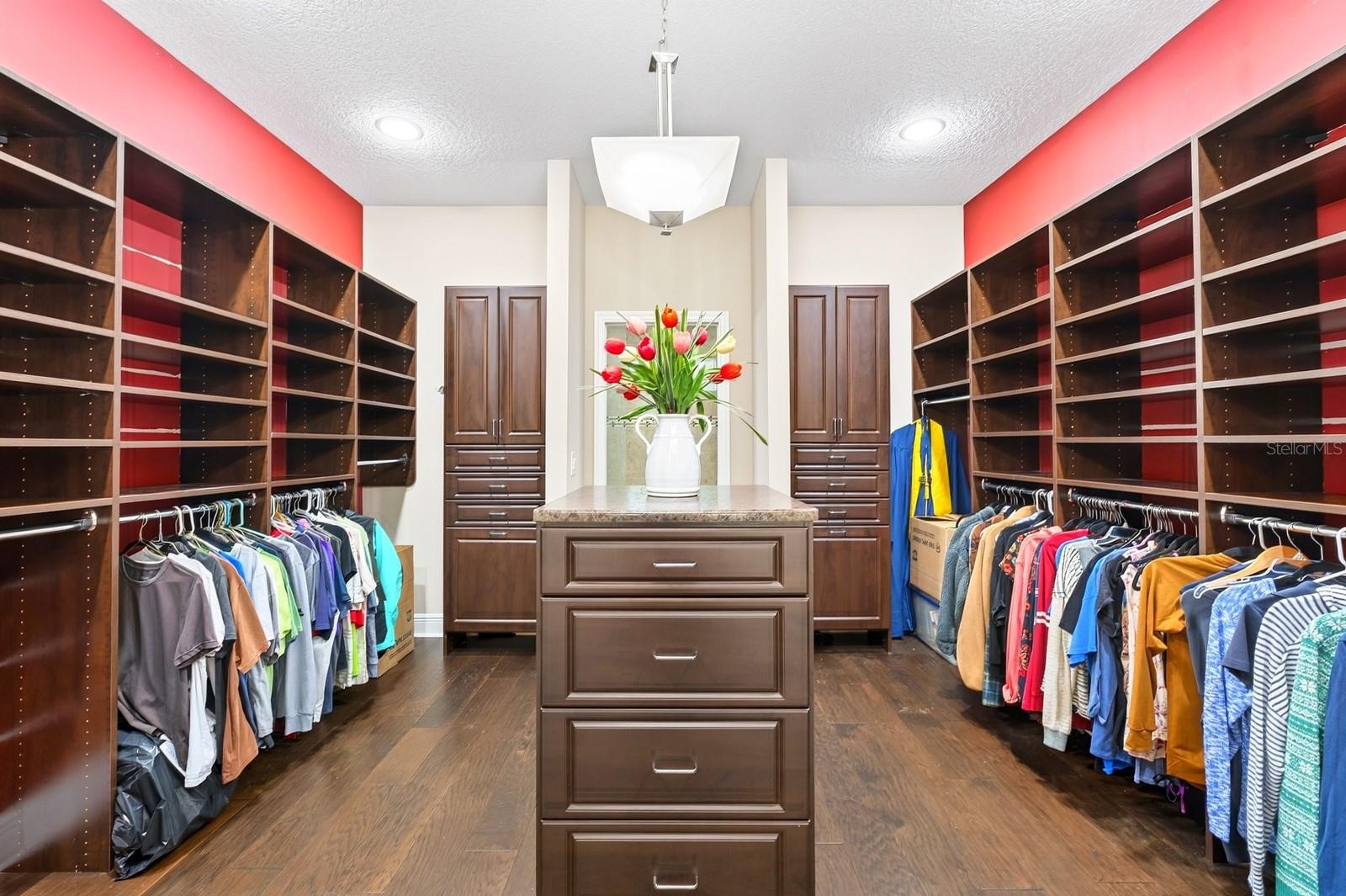 13x13 dual sided walk-in closet with custom storage.