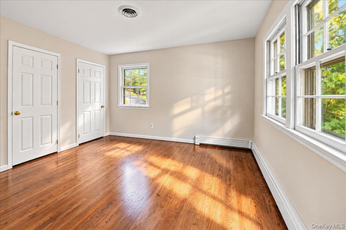 Bright and inviting primary bedroom featuring convenient bathroom access and two matching closets for ample storage.