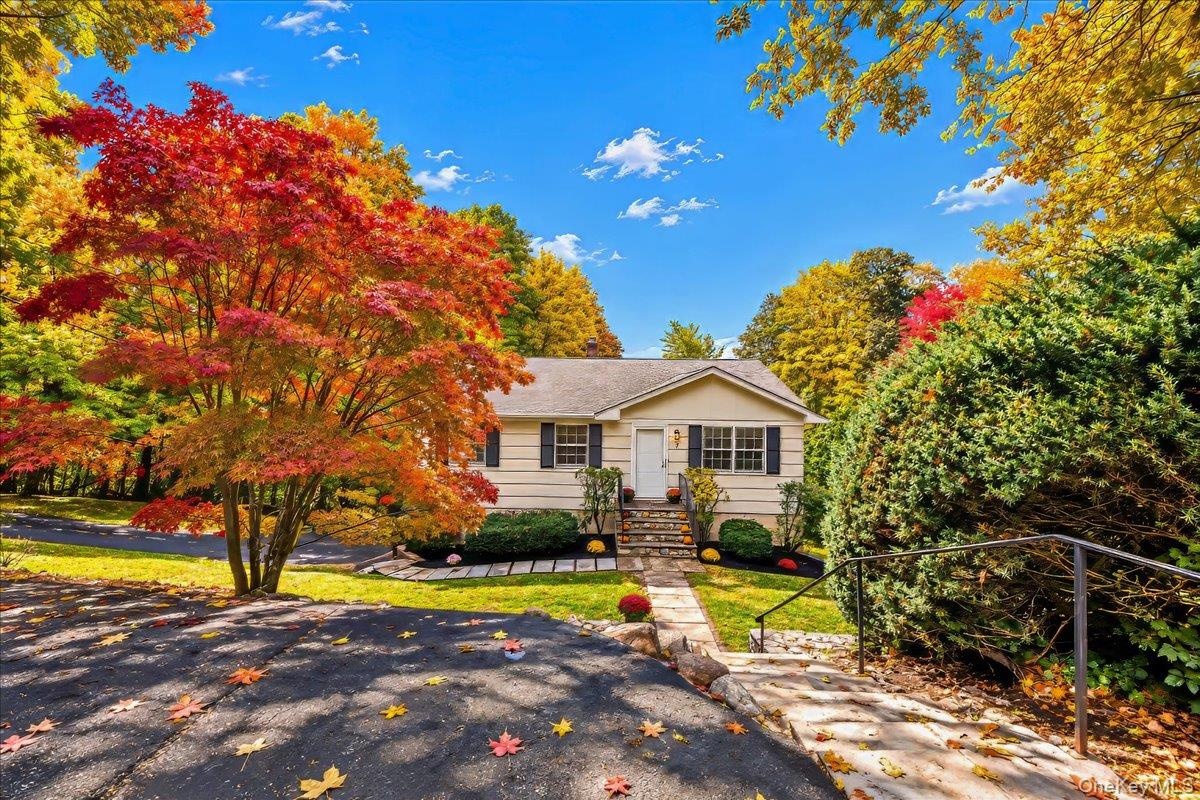 Long driveway leading to the garage, with an additional parking space conveniently located at the start of the walkway.