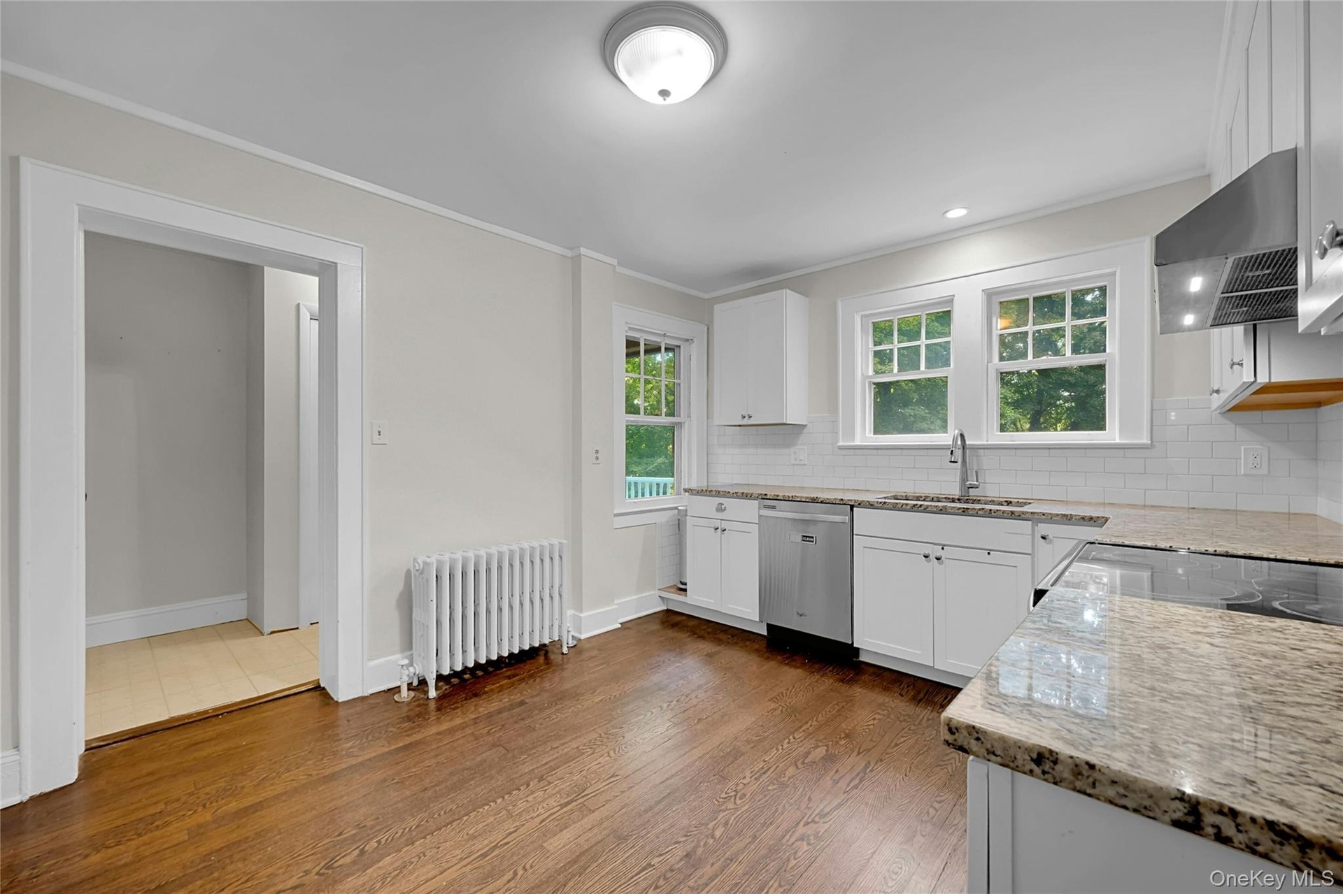 Entranceway leads to half-bath and backdoor hallway