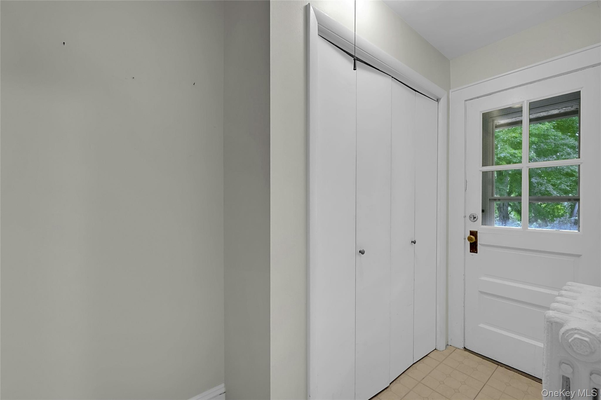 Backdoor hallway with closet