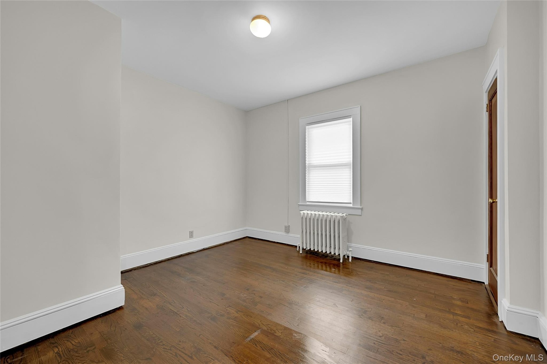 The smaller of the two rooms. Bedroom or Living Room / Office, you choose