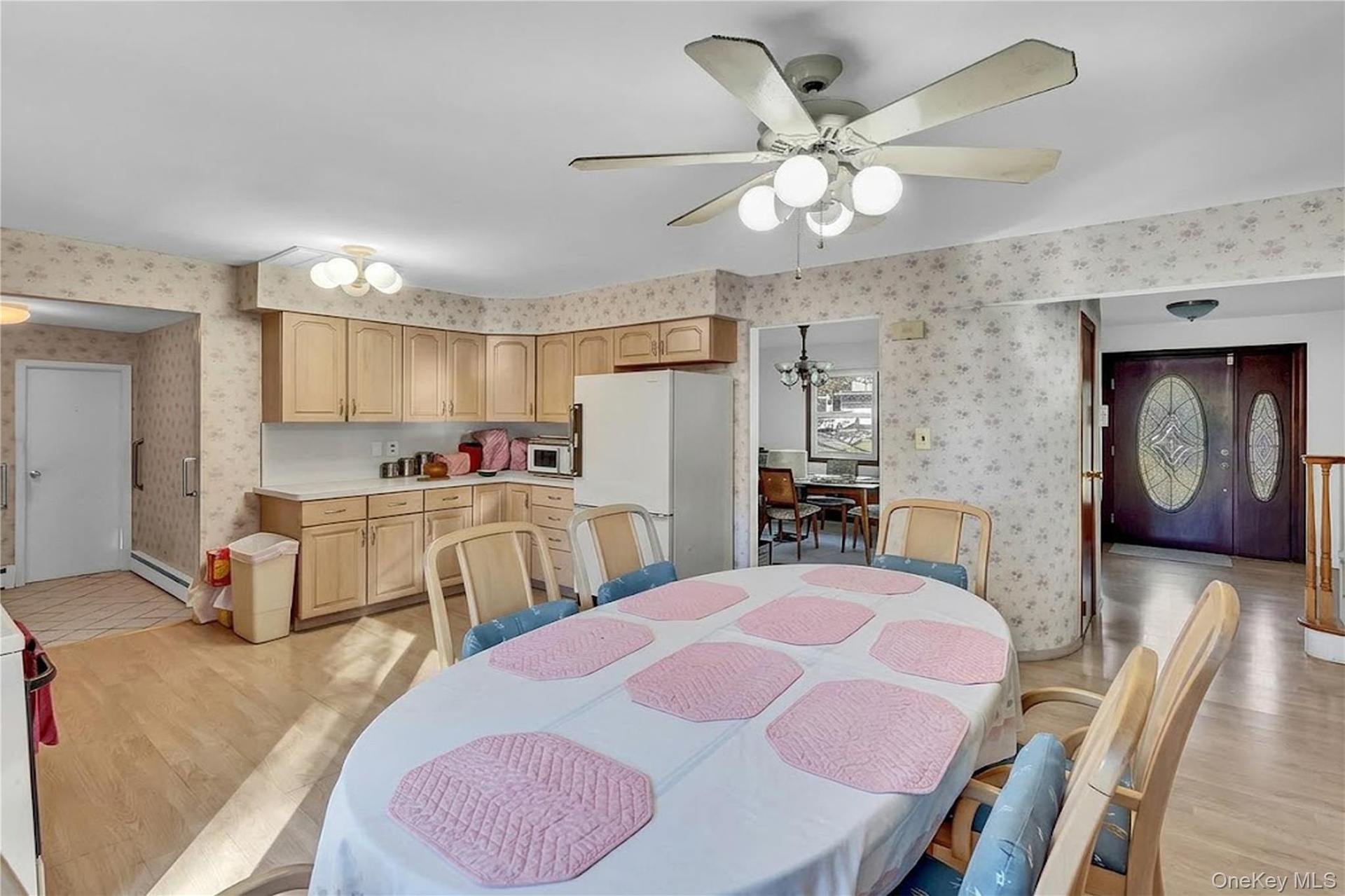 Kitchen featuring wood cabinetry, laminate countertops, and wood-finish flooring