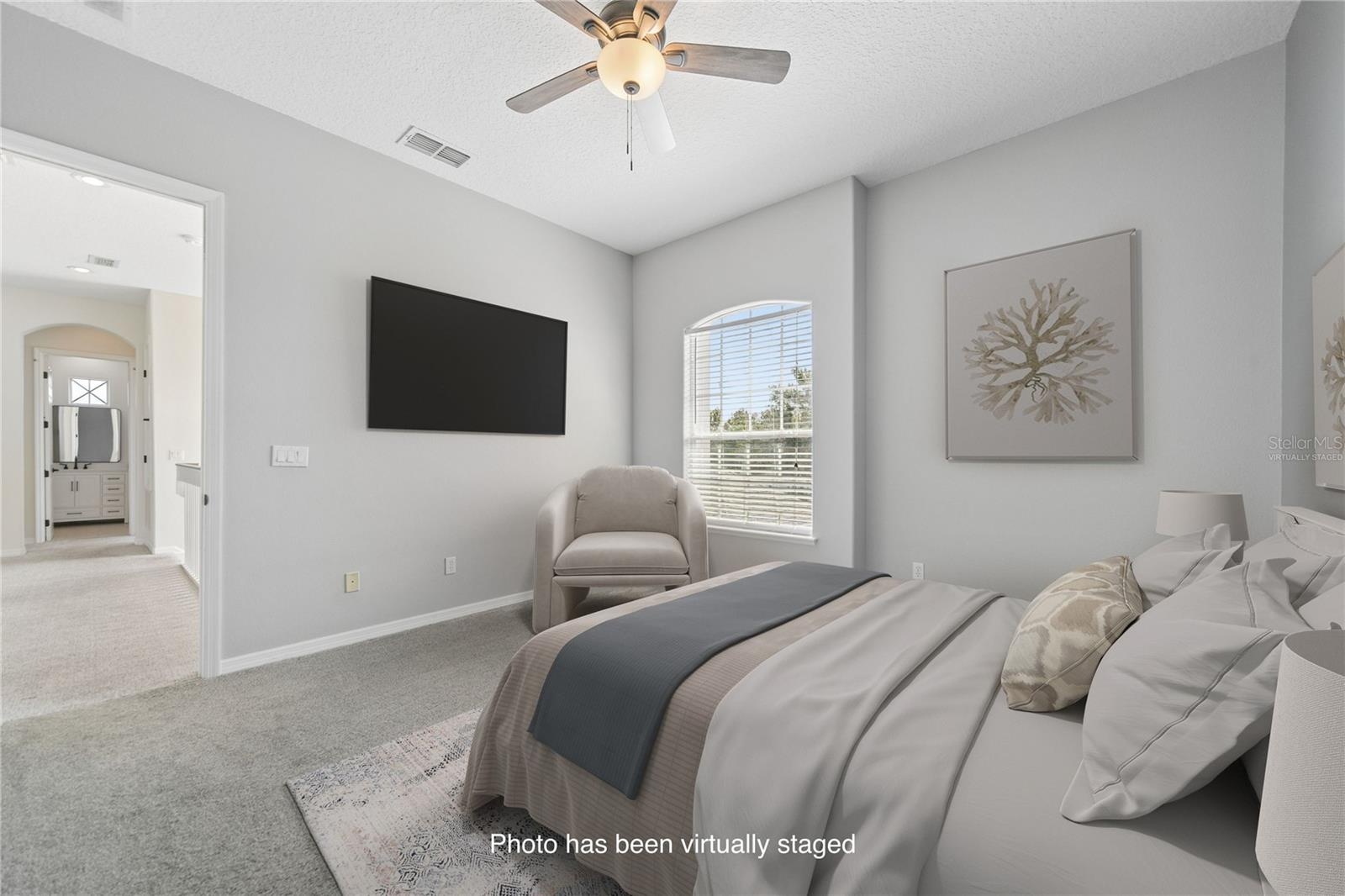 This is bedroom two with an ensuite and walk in closet for your guests or children to enjoy (photo virtually staged).
