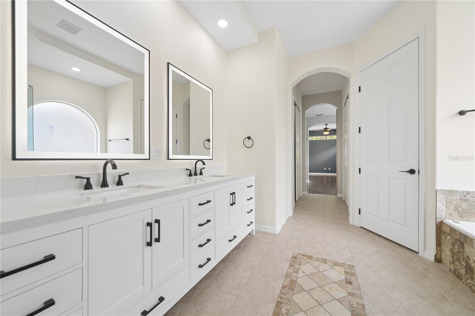 Walk past the two walk-in closets and into your primary bathroom with a water closet for your privacy.