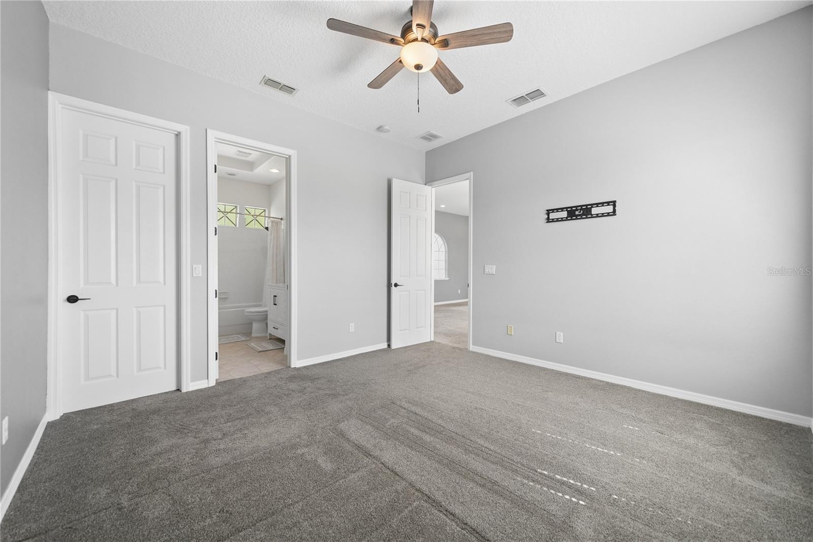 Bedroom two showing ensuite and closet door on the left.