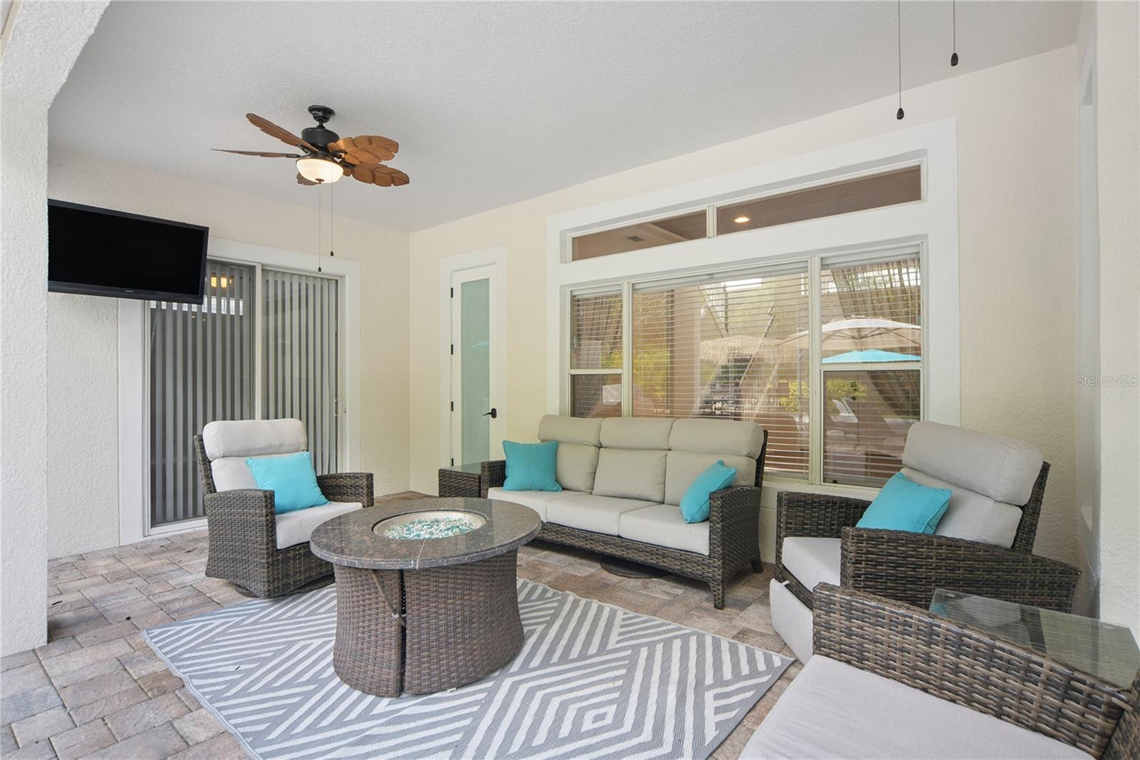 Right outside the family room sliding door is this spacious lanai where you can spend rainy days under cover, take a break from the bright sunshine, o