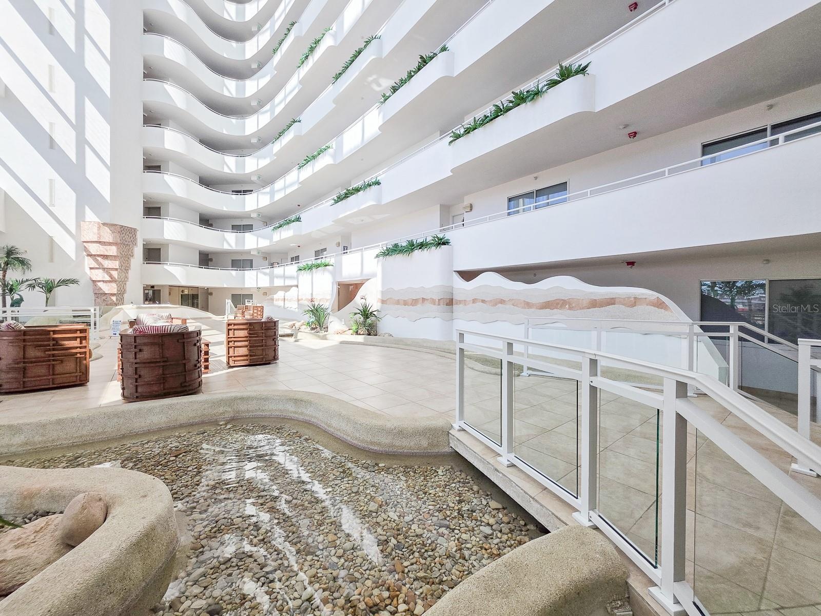 Lobby with waterfalls, streams and little bridges flowing throughout.